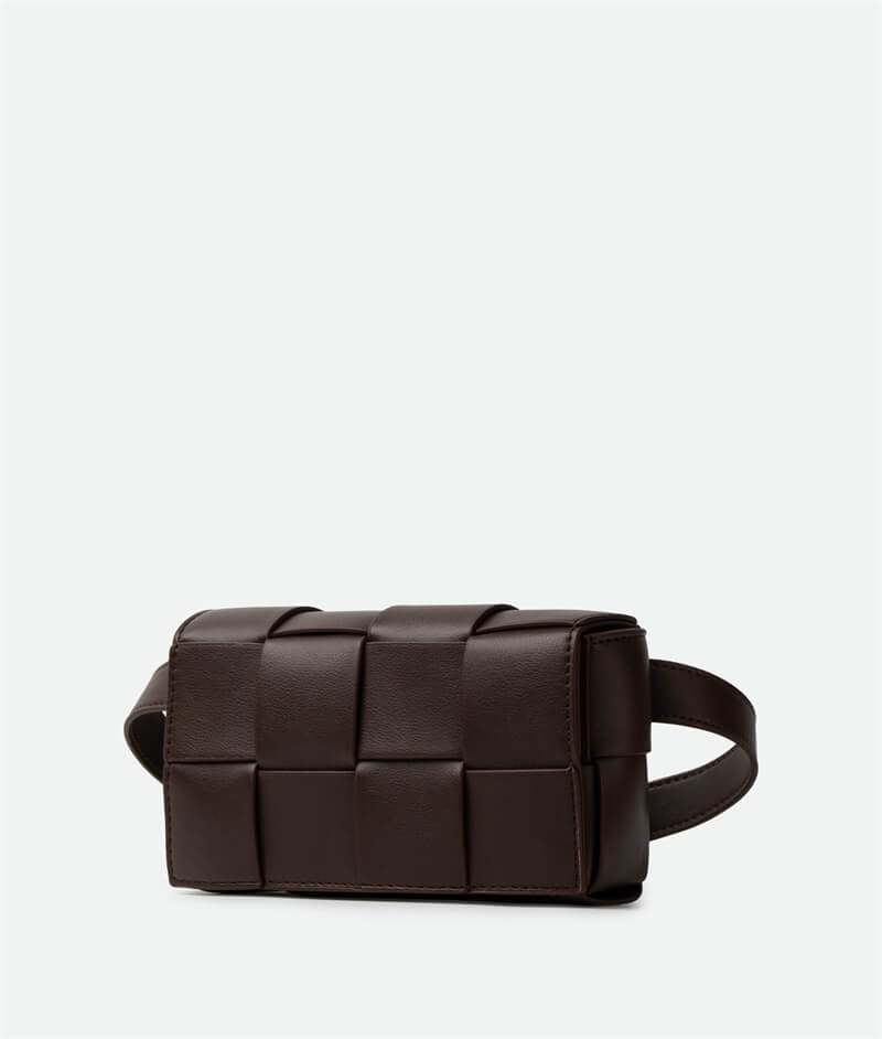 A brown mini cassette crossbody belt bag with a sleek design.