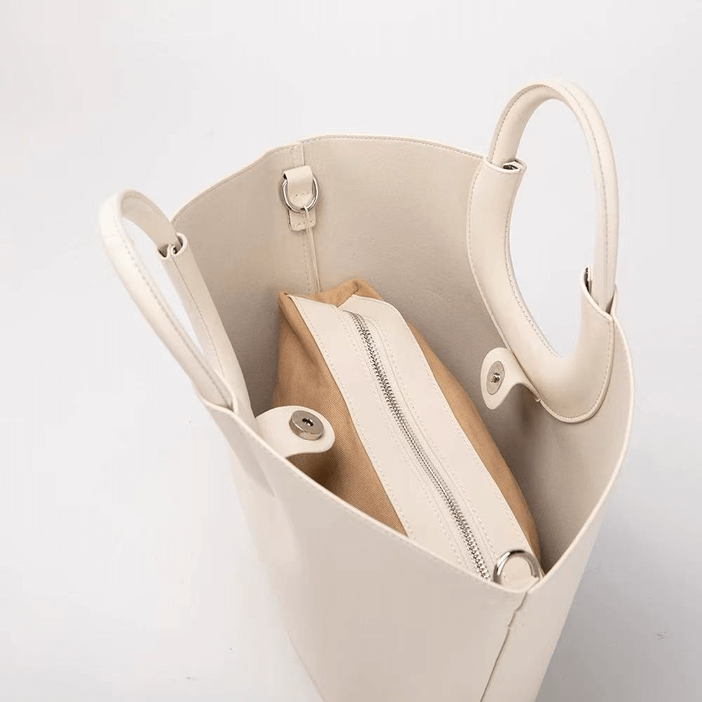 Beige handbag with a zipper pocket on a light gray background