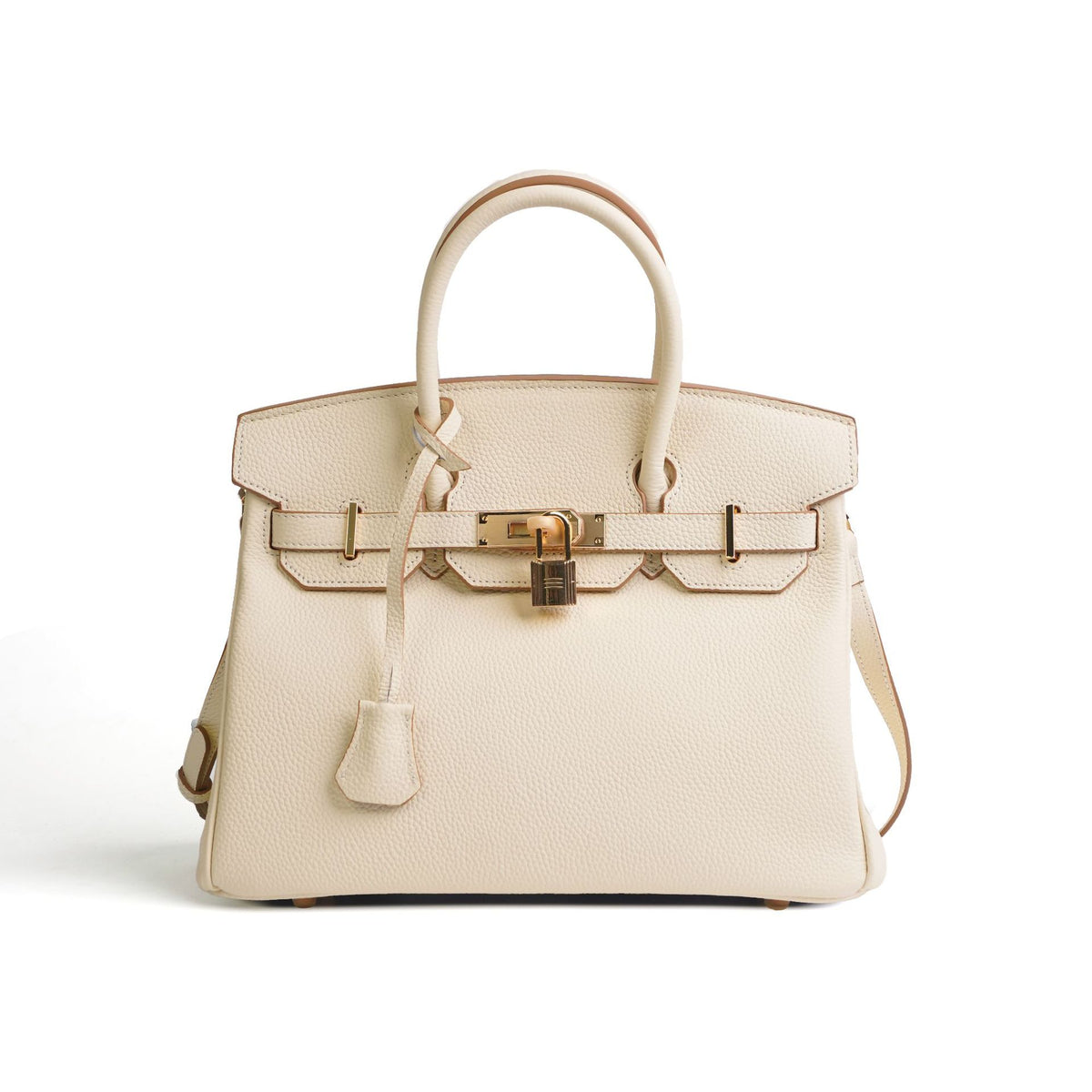 Beige handbag with gold hardware on a white background