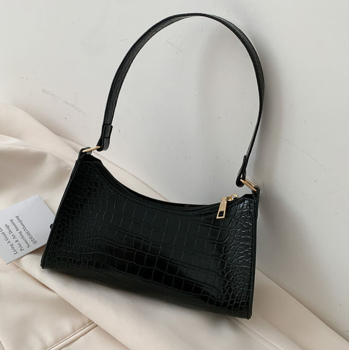 Black Crocodile Pattern Handbag On Beige Background