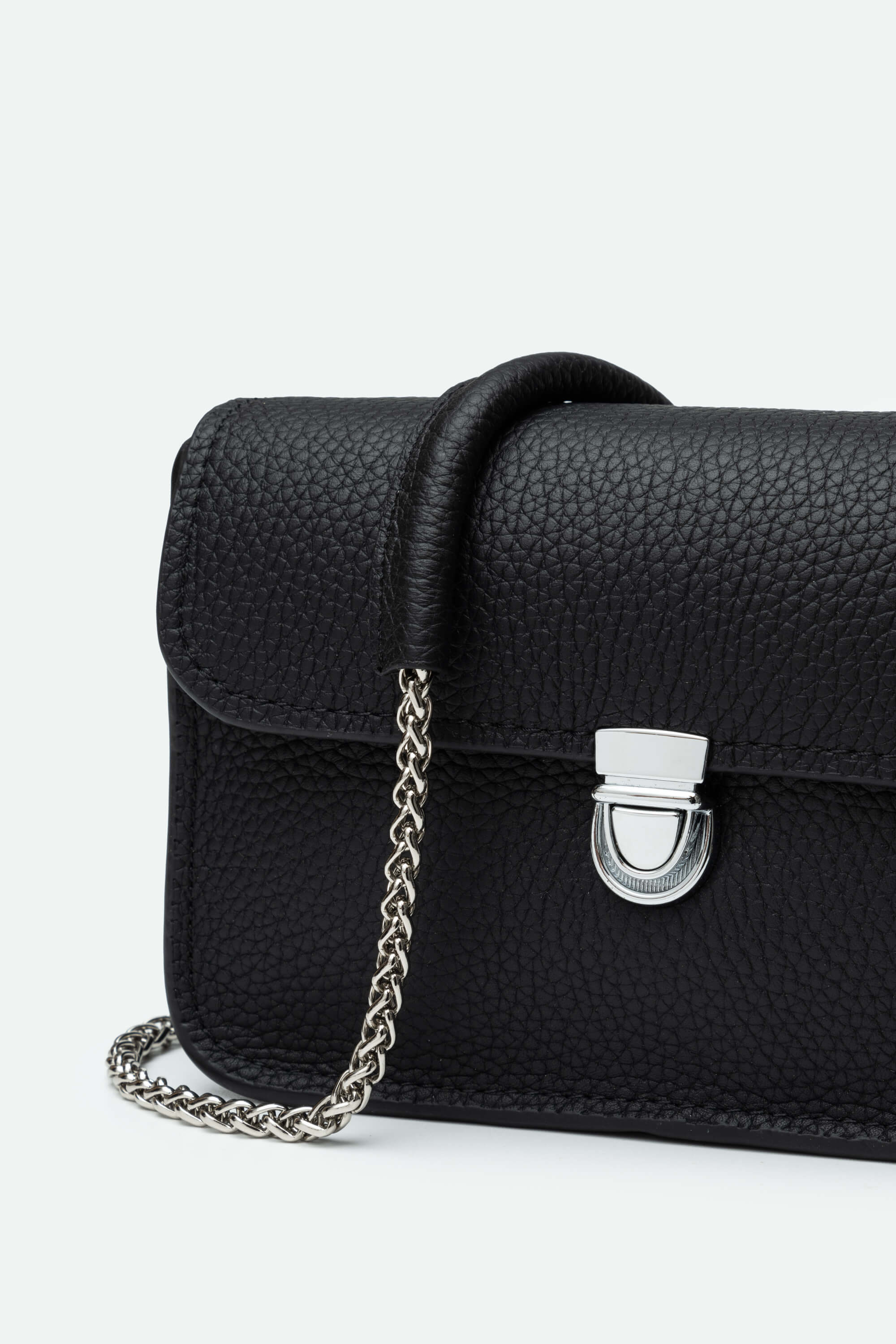 Black handbag with a chain detail on a white background