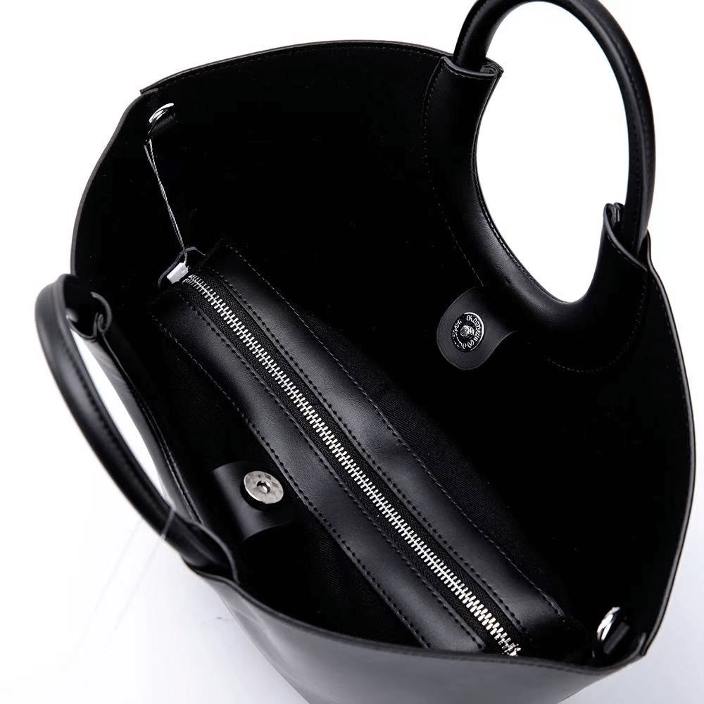 Black handbag with a zipper on a white background