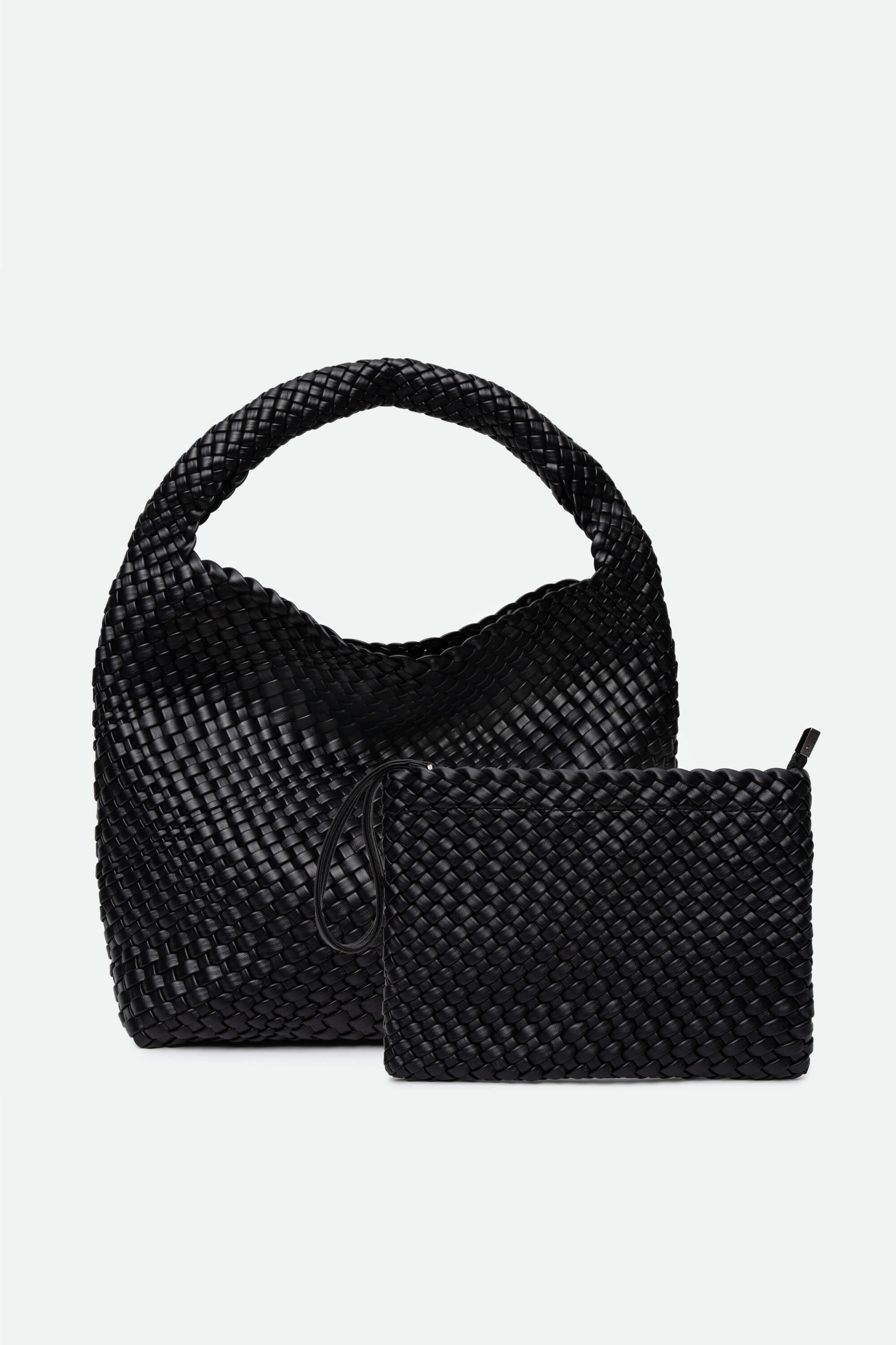 Black woven handbag and matching pouch on a light gray background