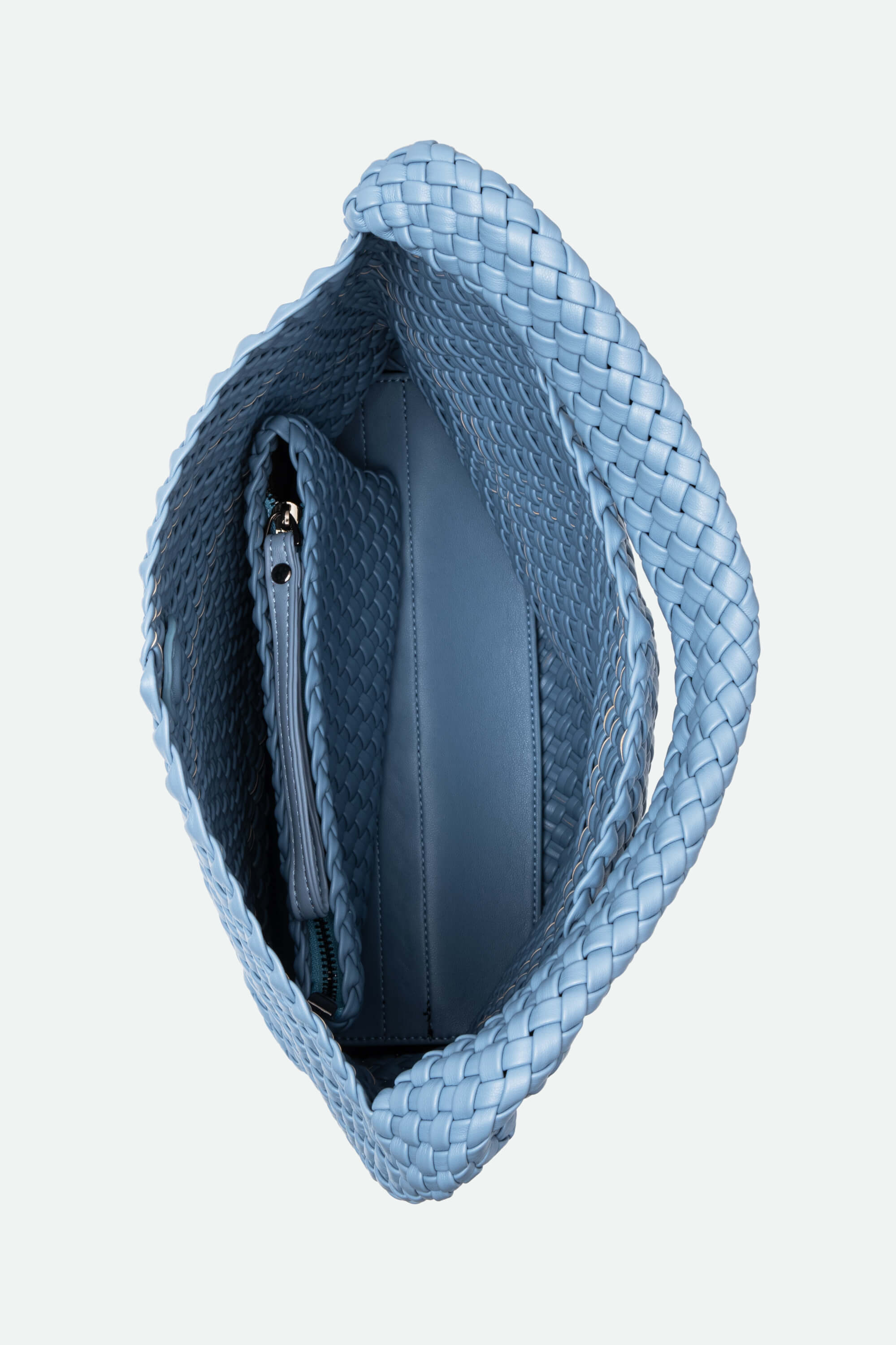 Blue woven handbag on a light gray background