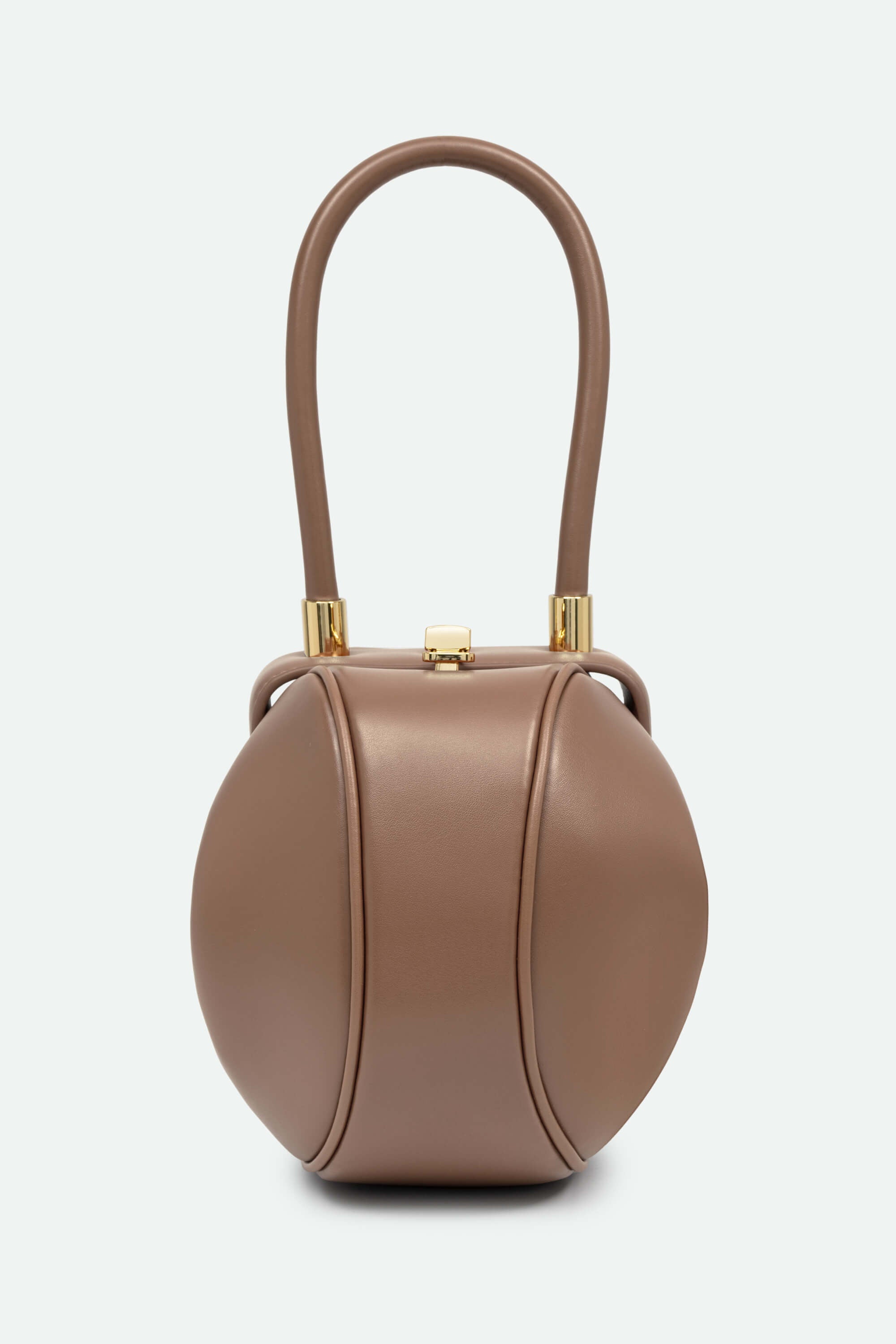 Brown handbag with a handle on a light gray background