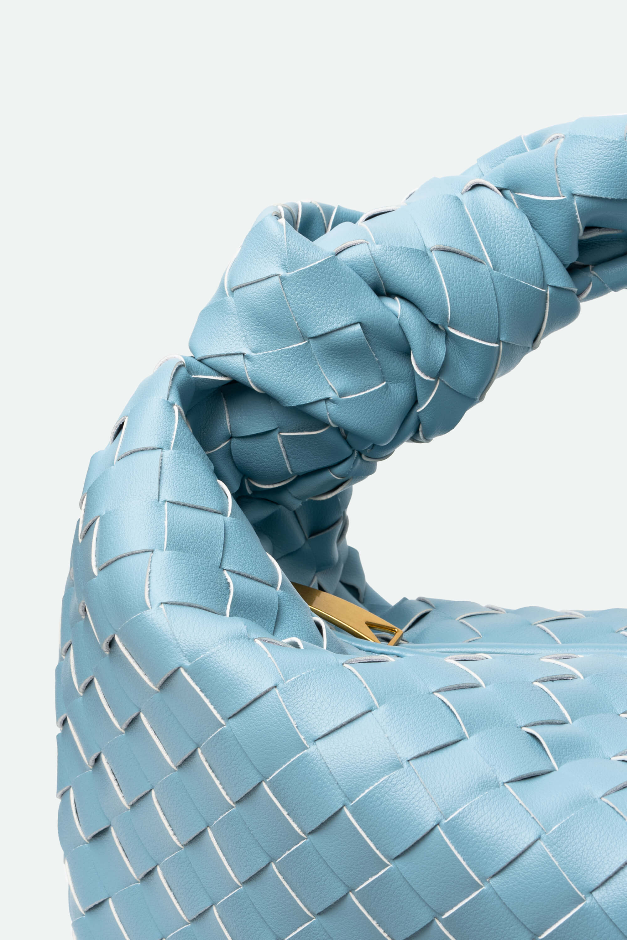 Close-up of a blue woven bag with a white background