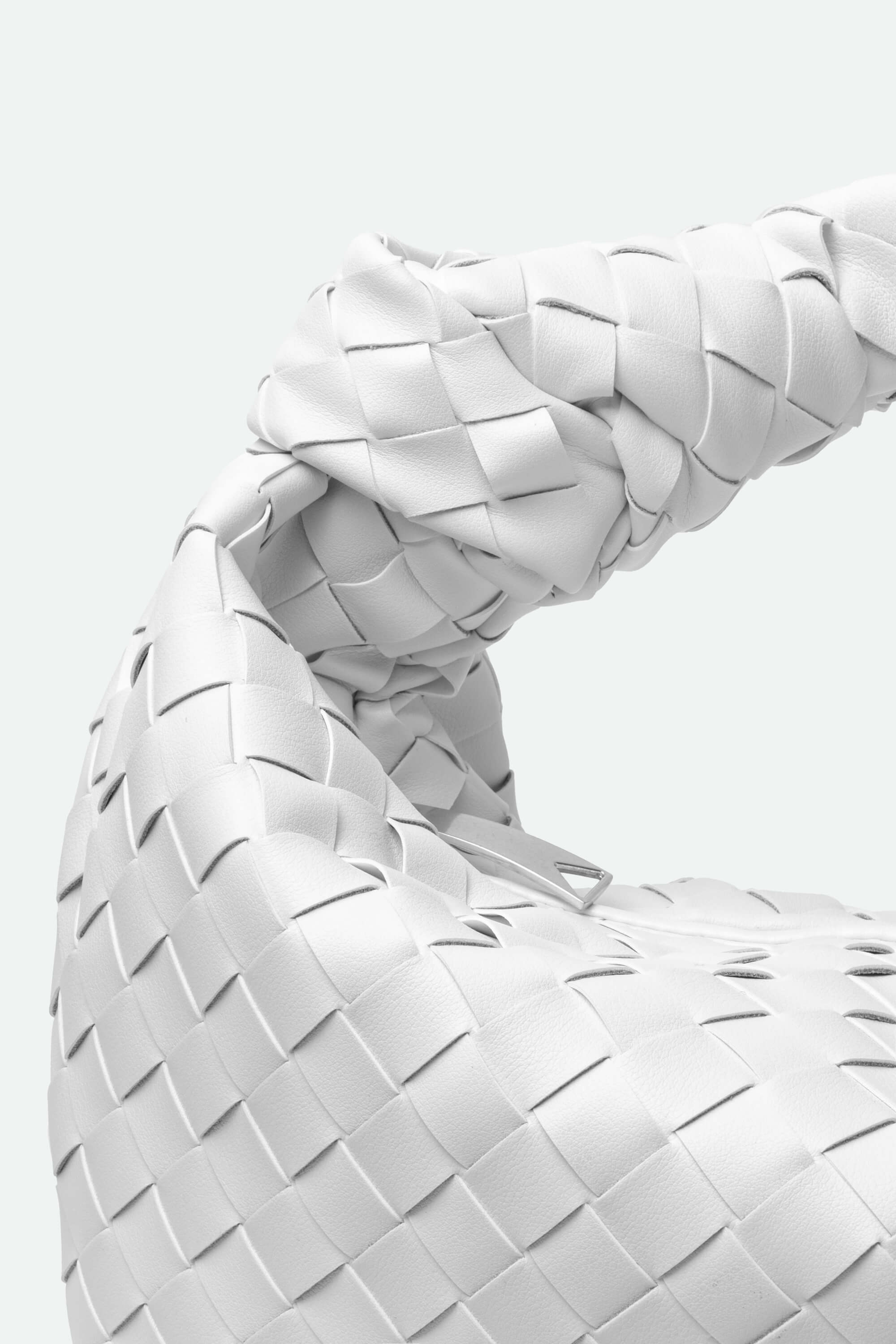 Close-up of a woven white chair with a blurred background