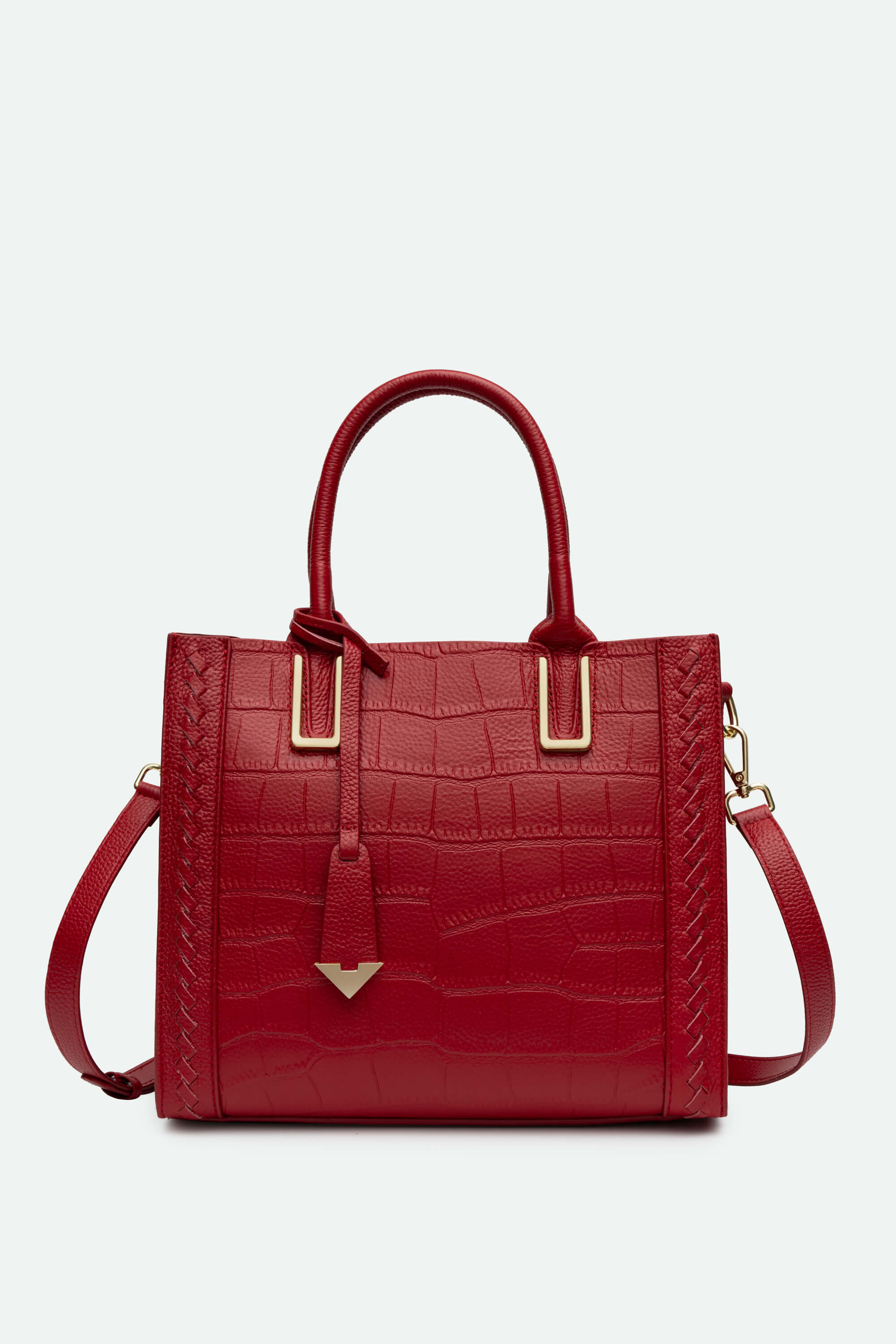 Red handbag with gold accents on a light gray background
