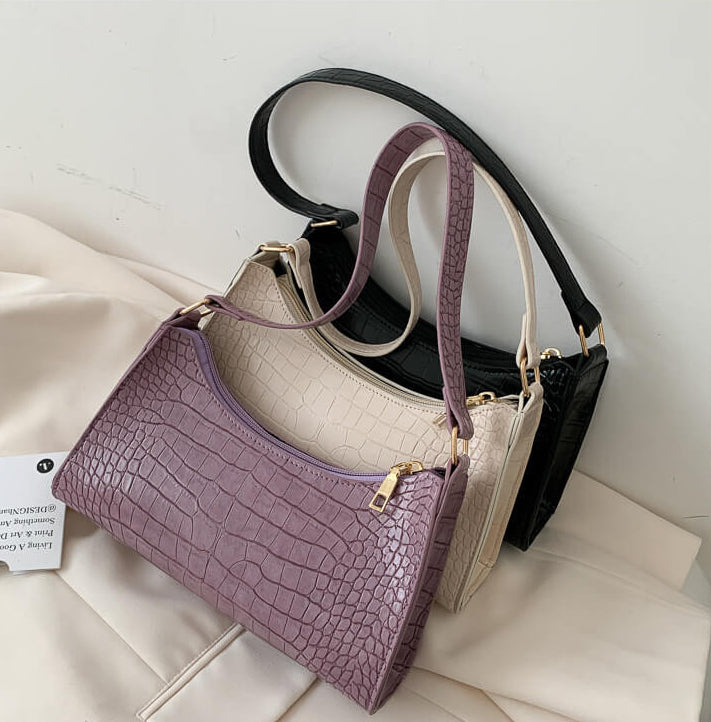 Crocodile Pattern Handbags on beige background