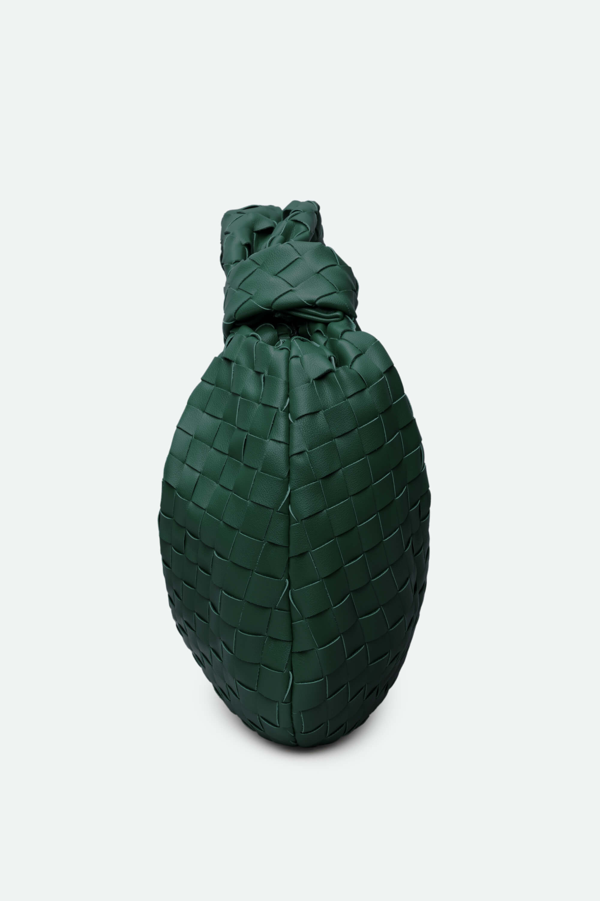 Green woven bag on a light gray background