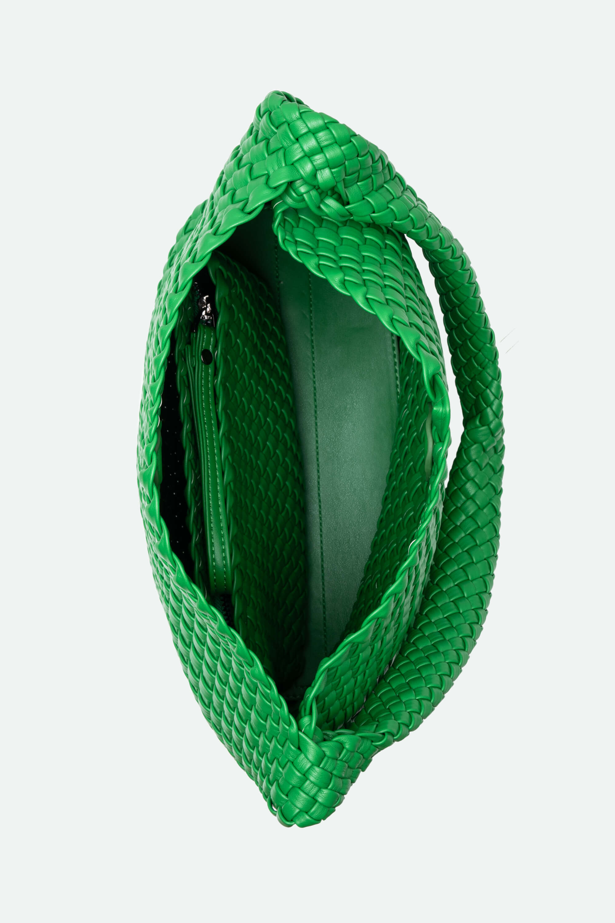 Green woven handbag on a light gray background