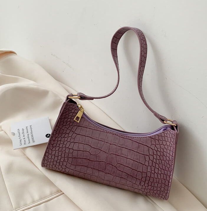 Purple Crocodile Pattern Handbag on beige