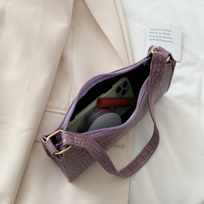 Purple Crocodile Pattern Handbag on beige background