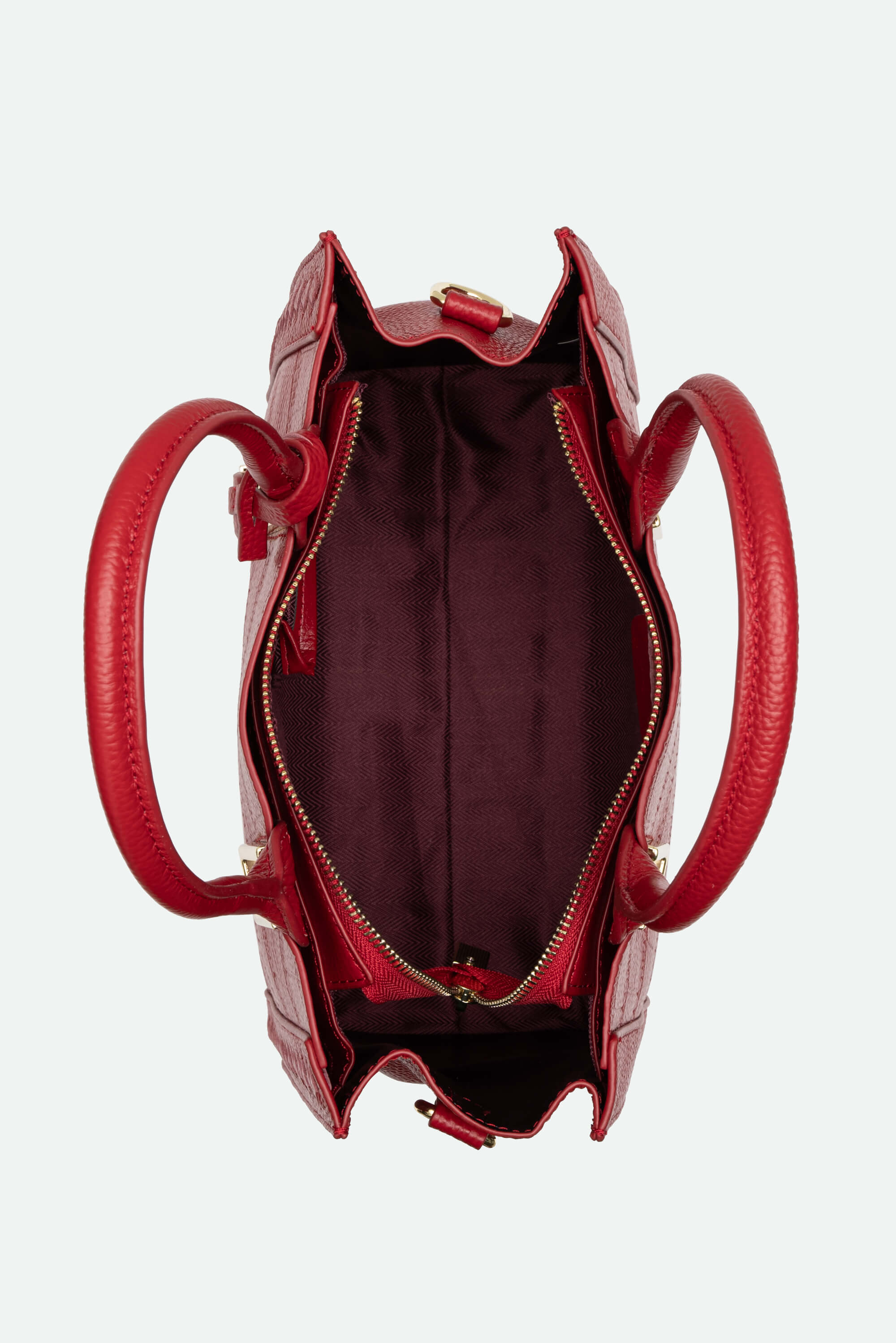 Red handbag with a textured surface on a white background