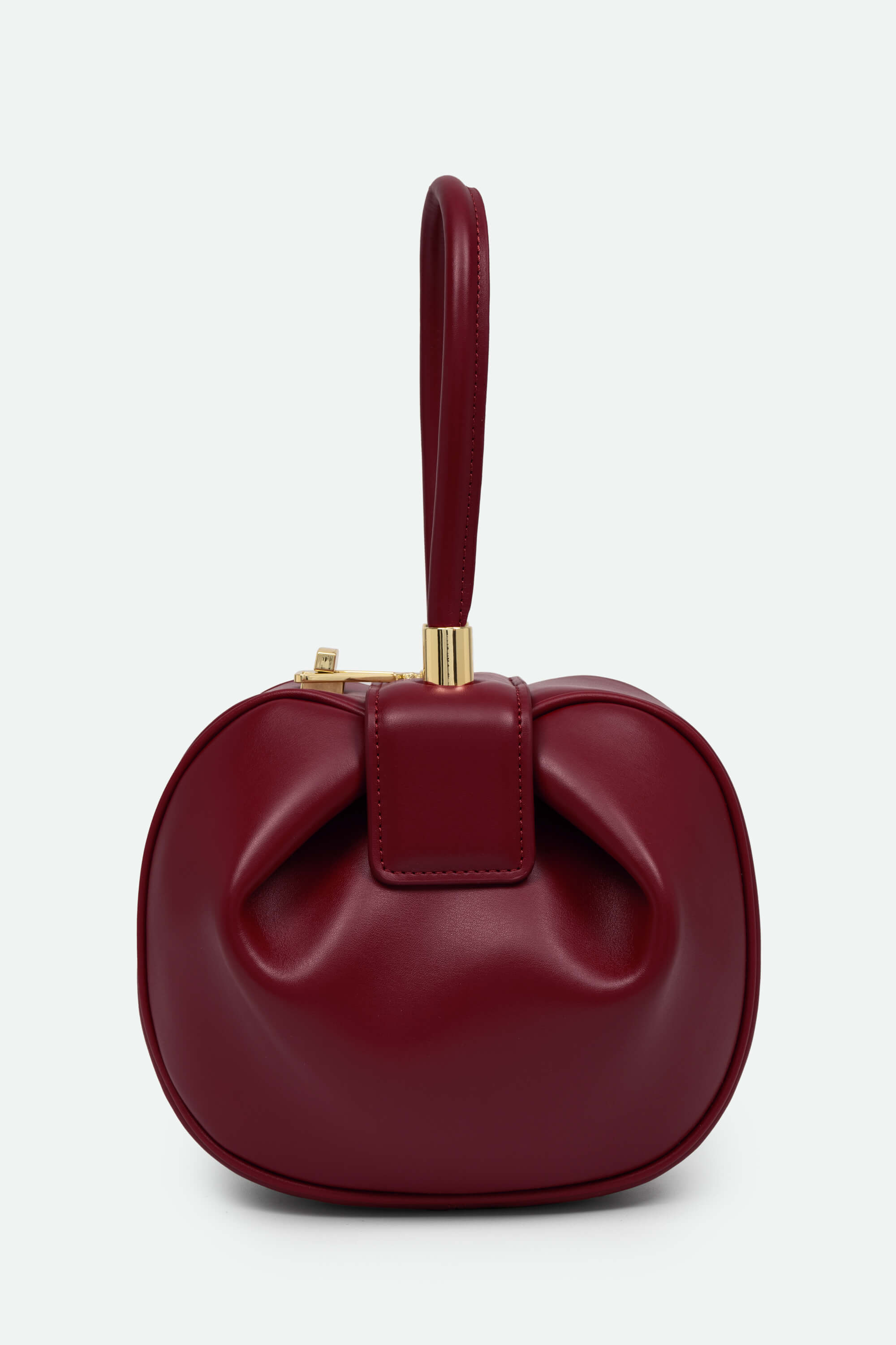 Red handbag with a bow design on a white background