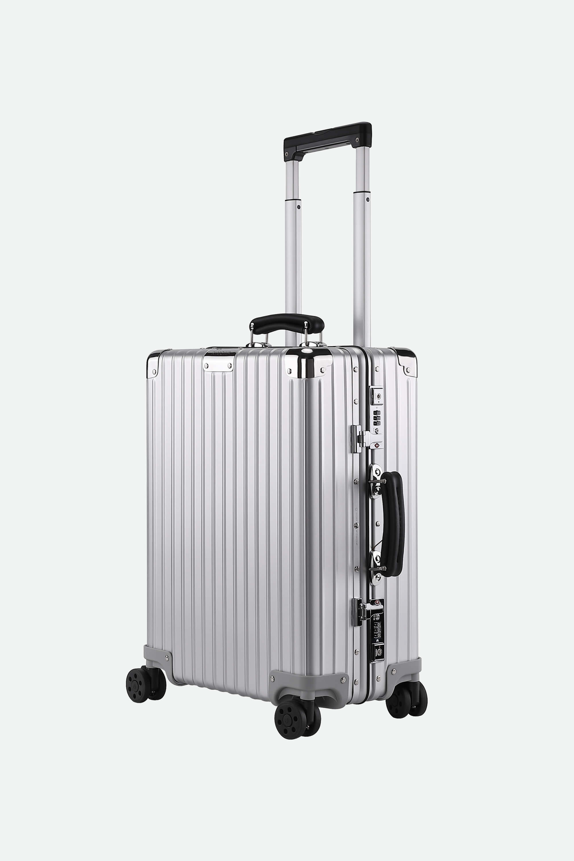 Silver suitcase with black handles and wheels on a white background