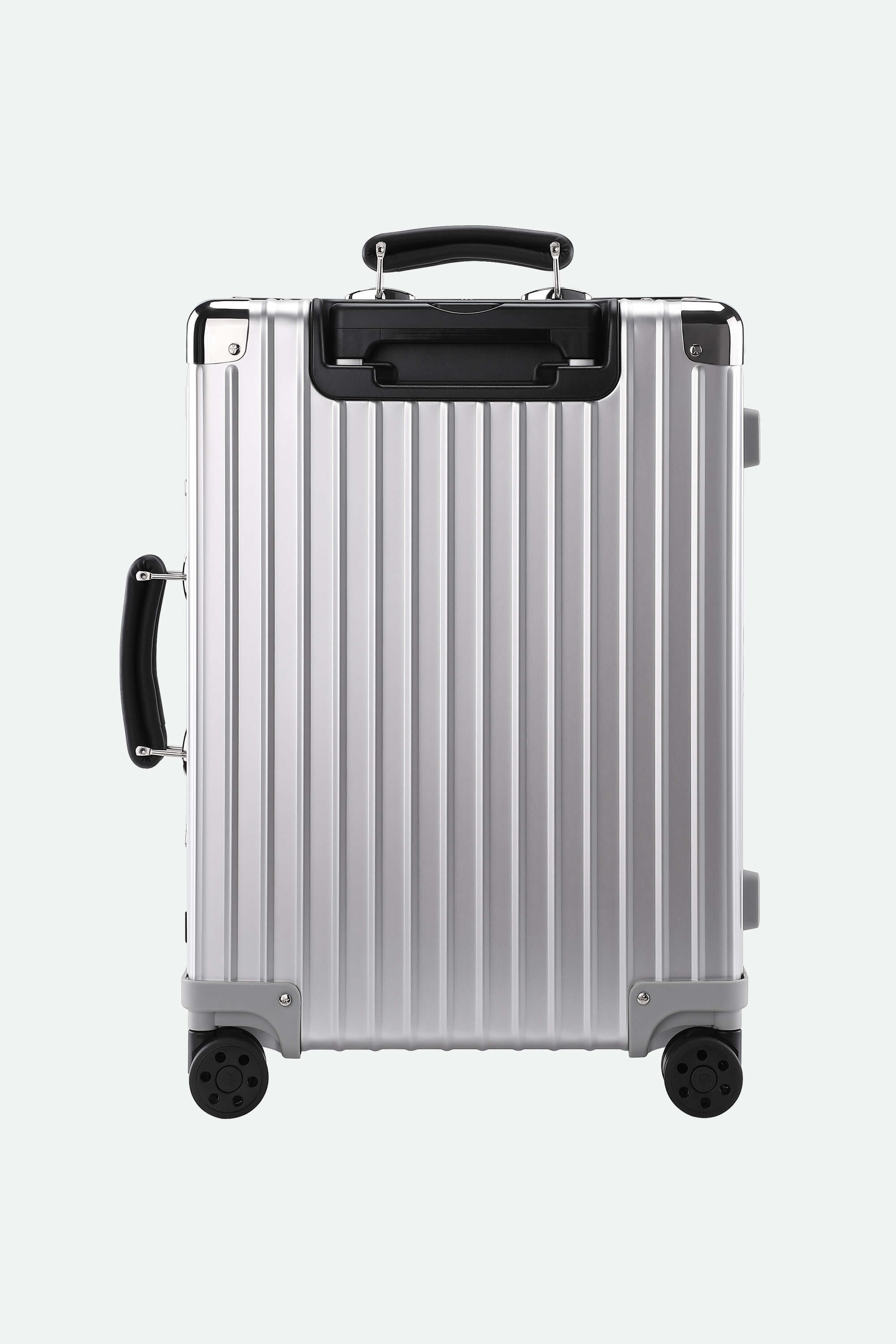 Silver suitcase with black handles and wheels on a white background