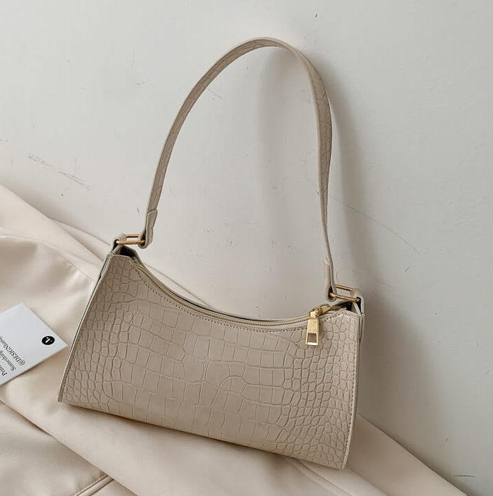 White Crocodile Pattern Handbag on beige background