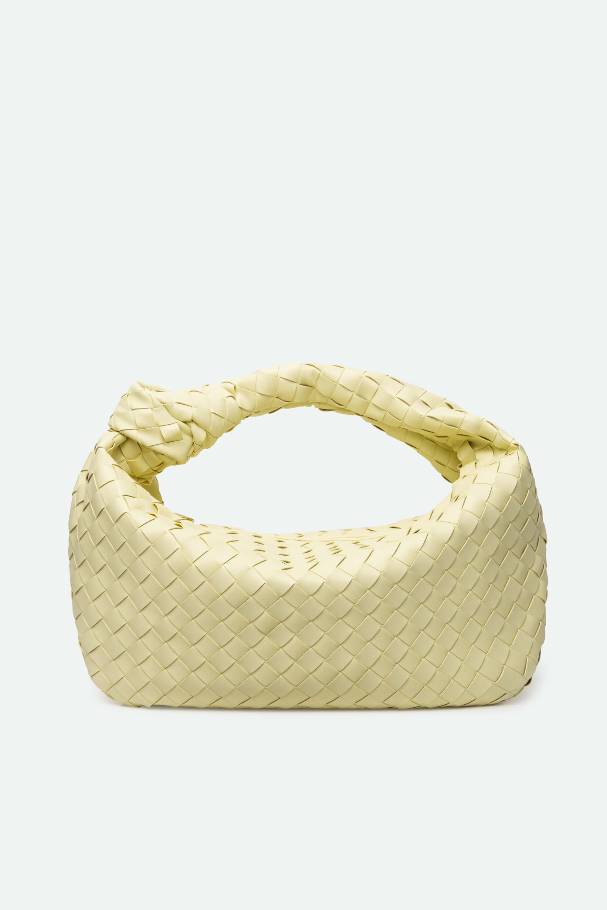 Yellow woven handbag on a light gray background