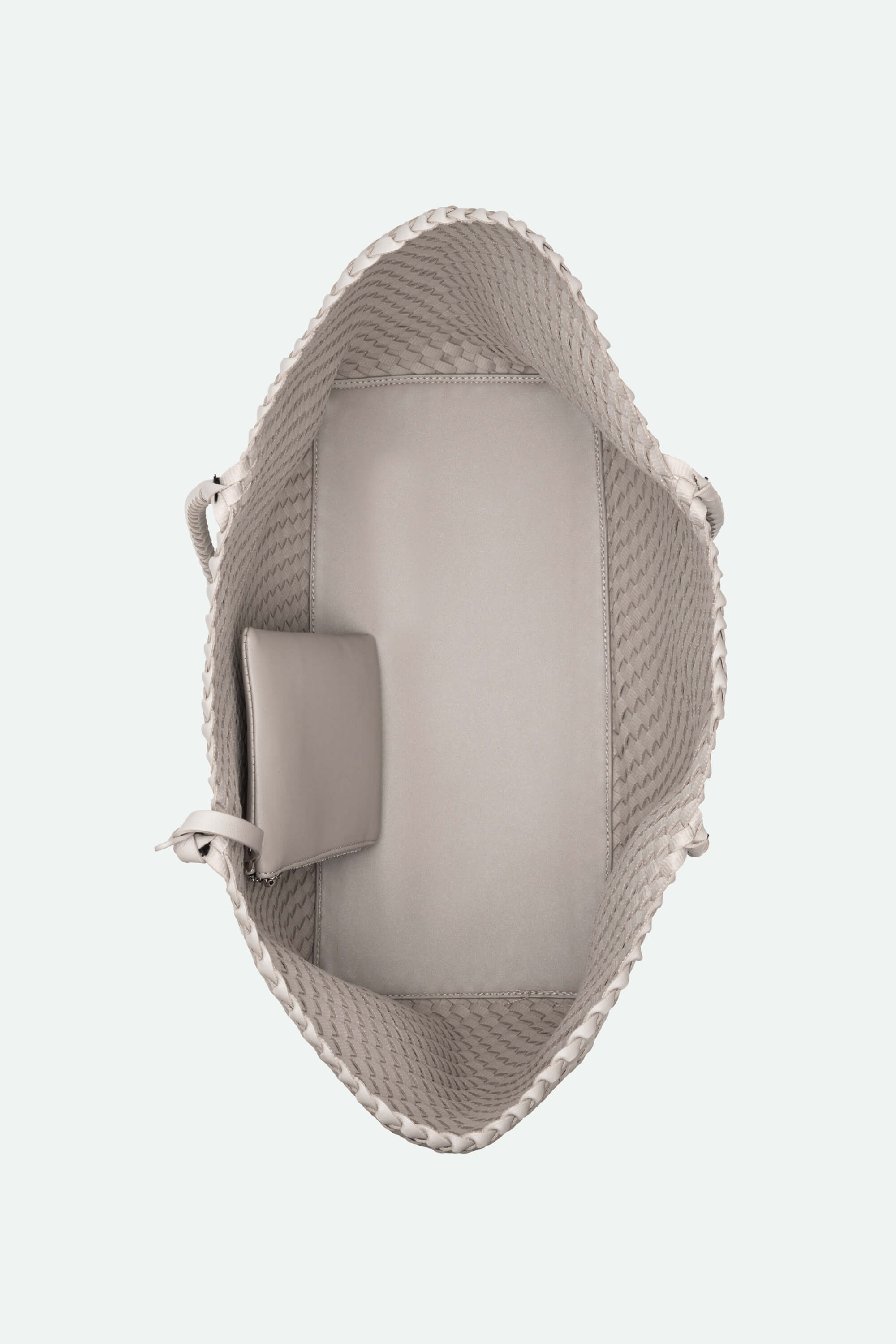 a large woven handbag against a white background