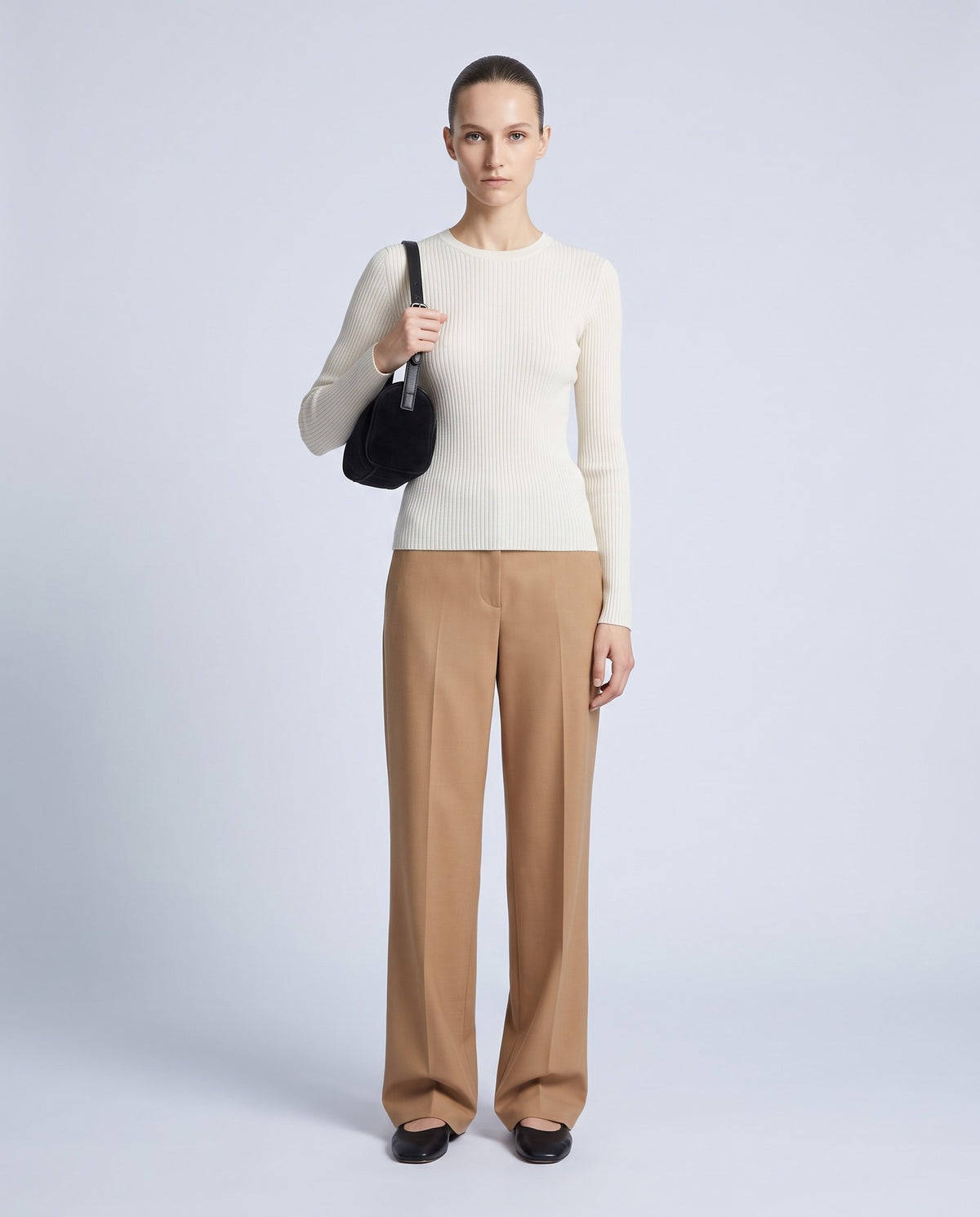 Model wearing the Alba barrel shoulder bag in Onyx black suede – full length