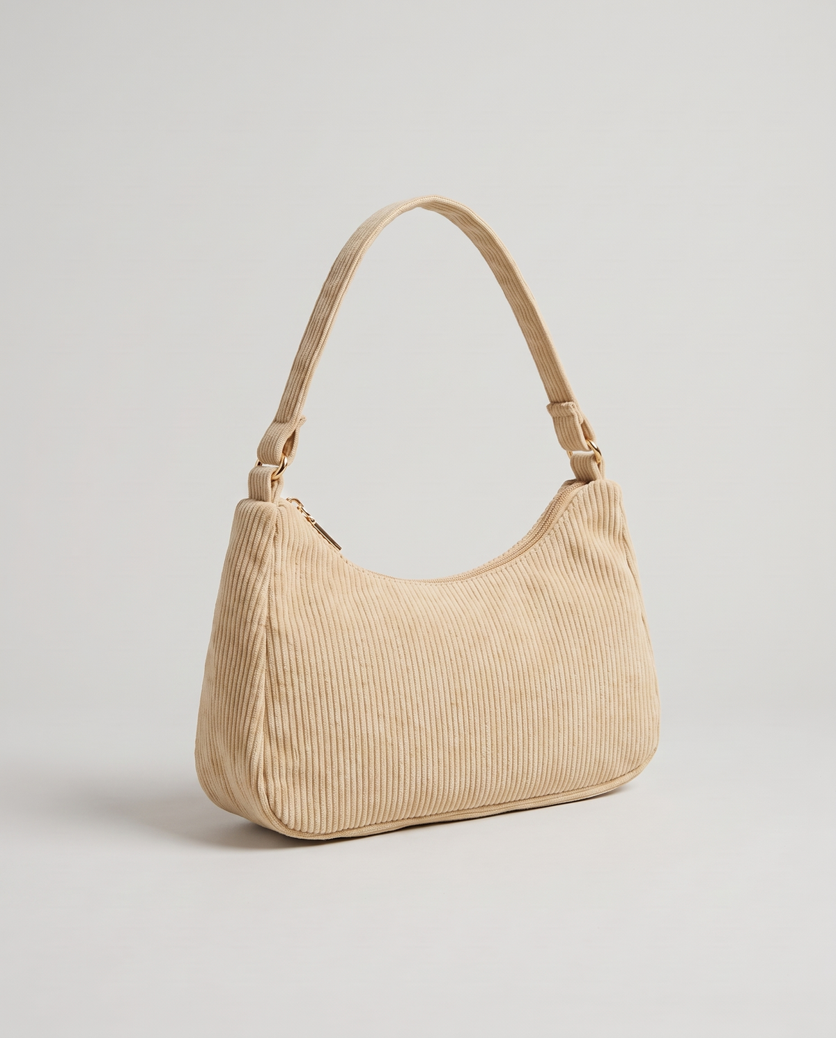 Aura corduroy shoulder bag in Beige – three-quarter view