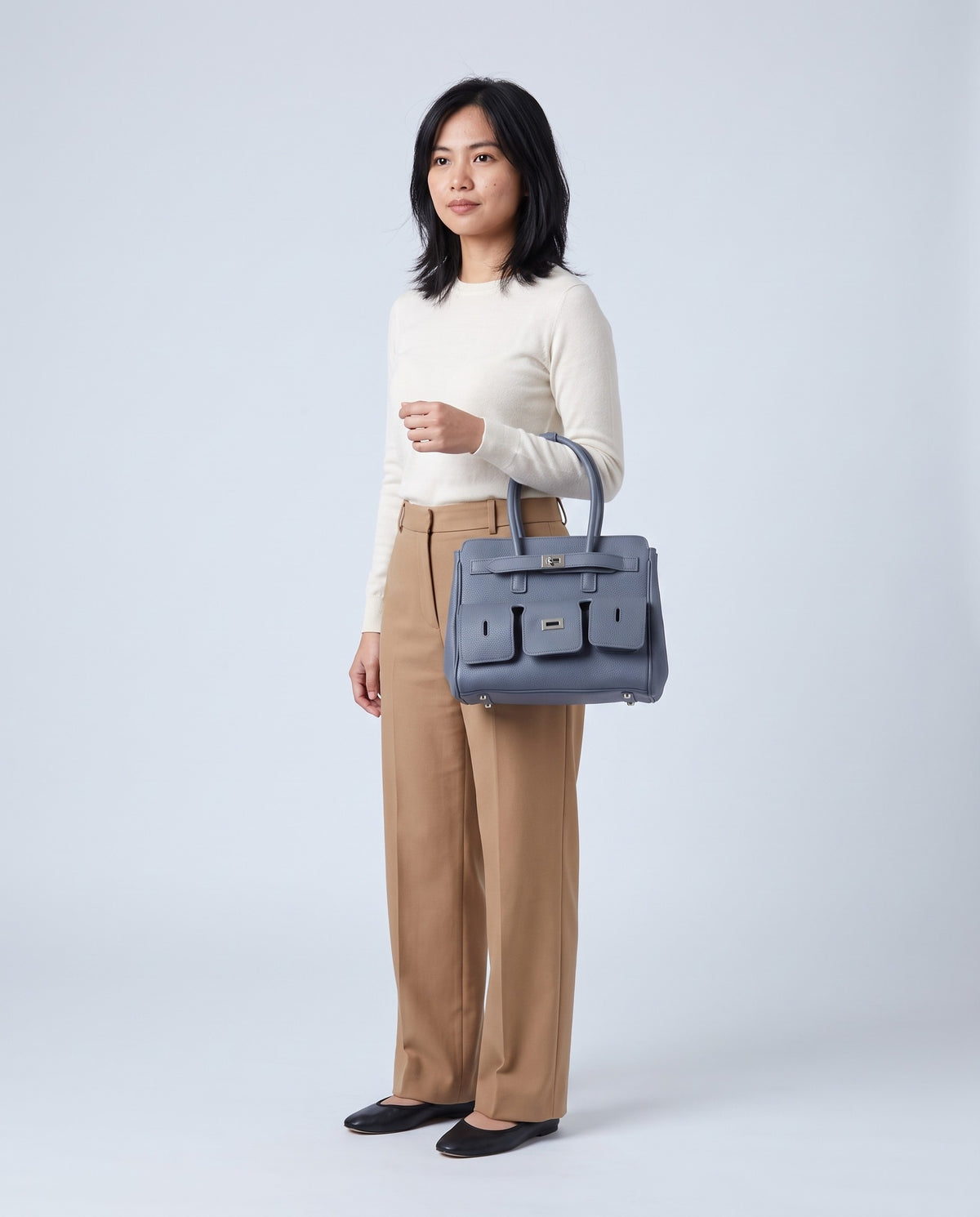 Model carrying the Capua leather tote in Denim – full length
