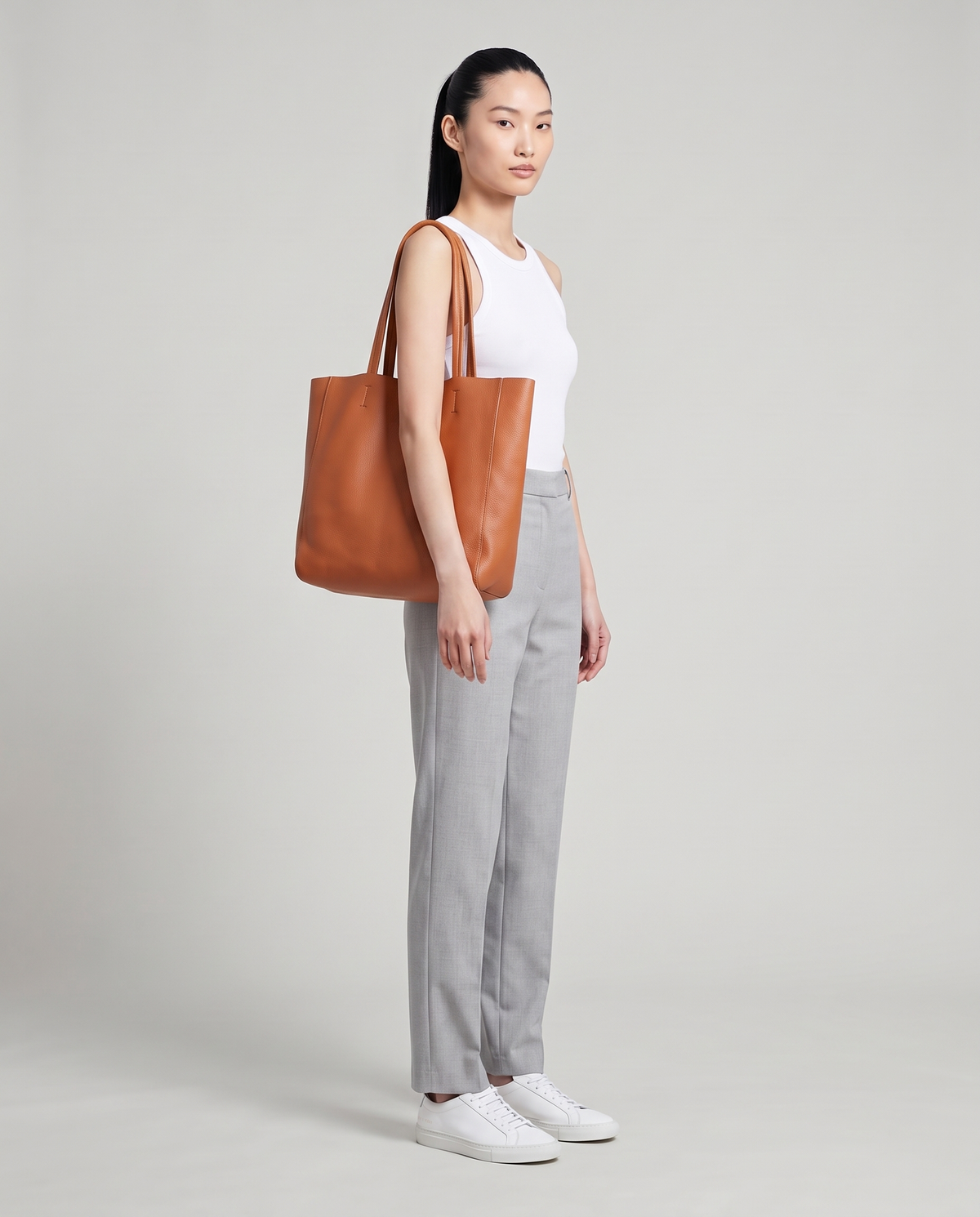 Model with the Costa leather tote in cognac, full length