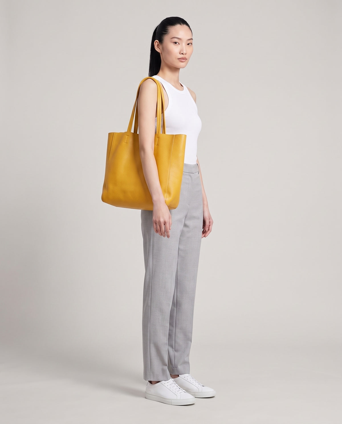 Model with the Costa leather tote in mustard, full length