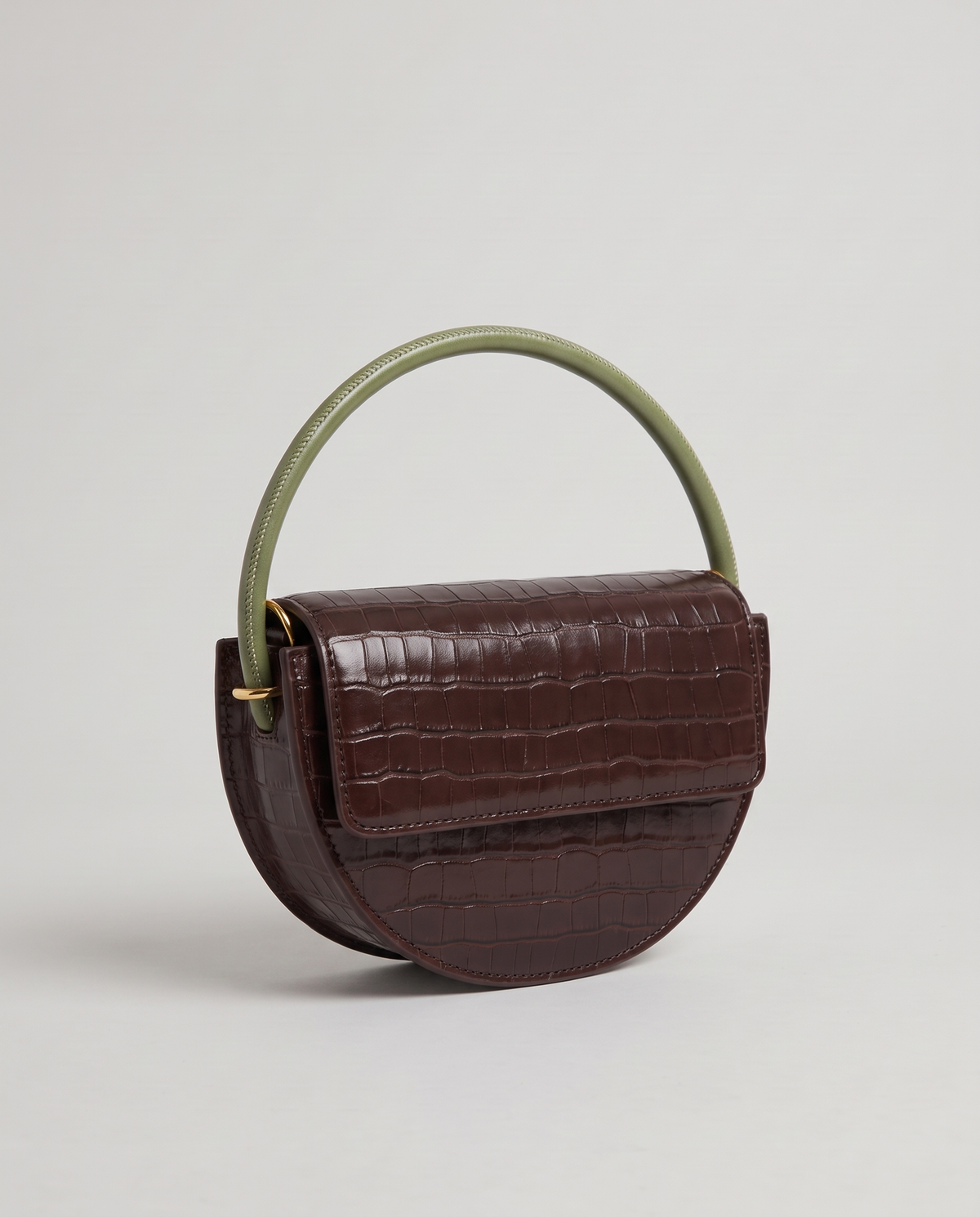 Crescent croc-embossed half-moon bag in Brown – three-quarter view