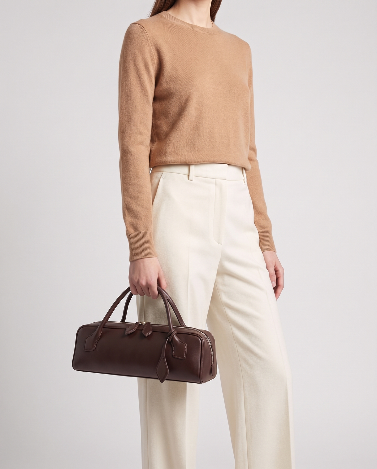 Curve leather barrel bag in Brown – model carrying it