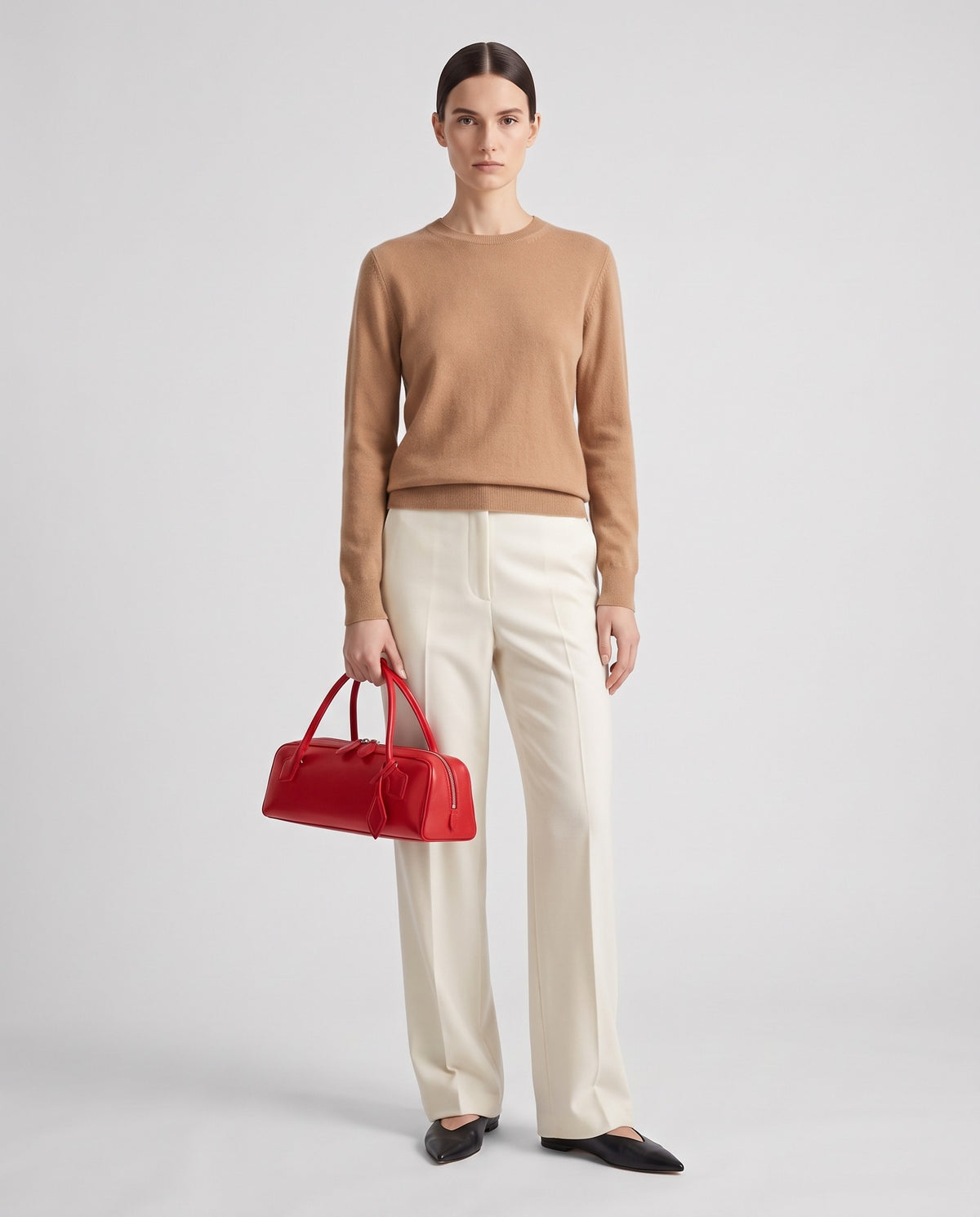 Curve leather barrel bag in Red – model holding it, full length