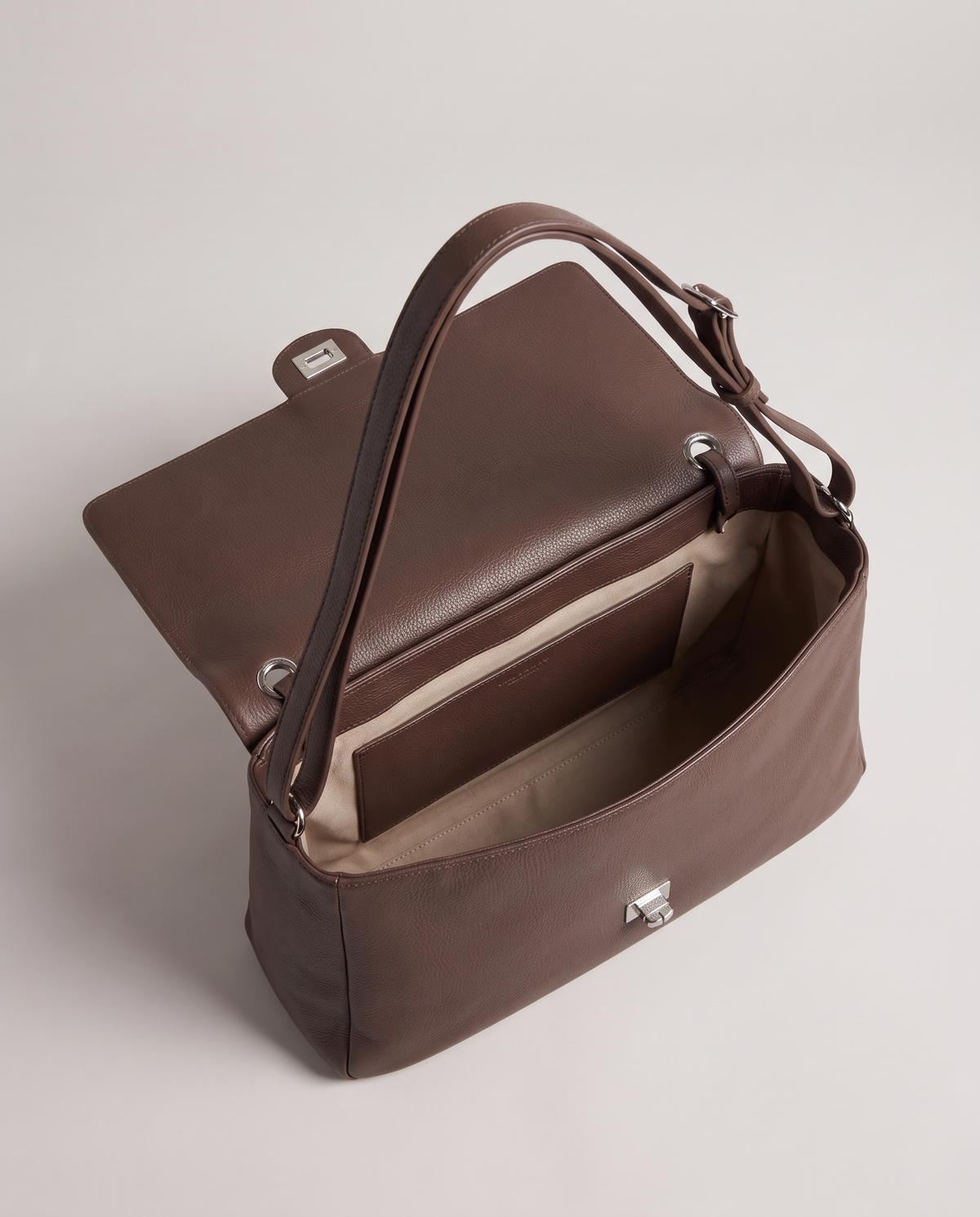 Fiume leather shoulder bag in brown, open showing interior