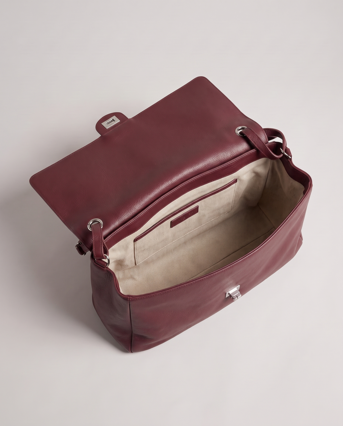 Fiume leather shoulder bag in burgundy, open showing interior