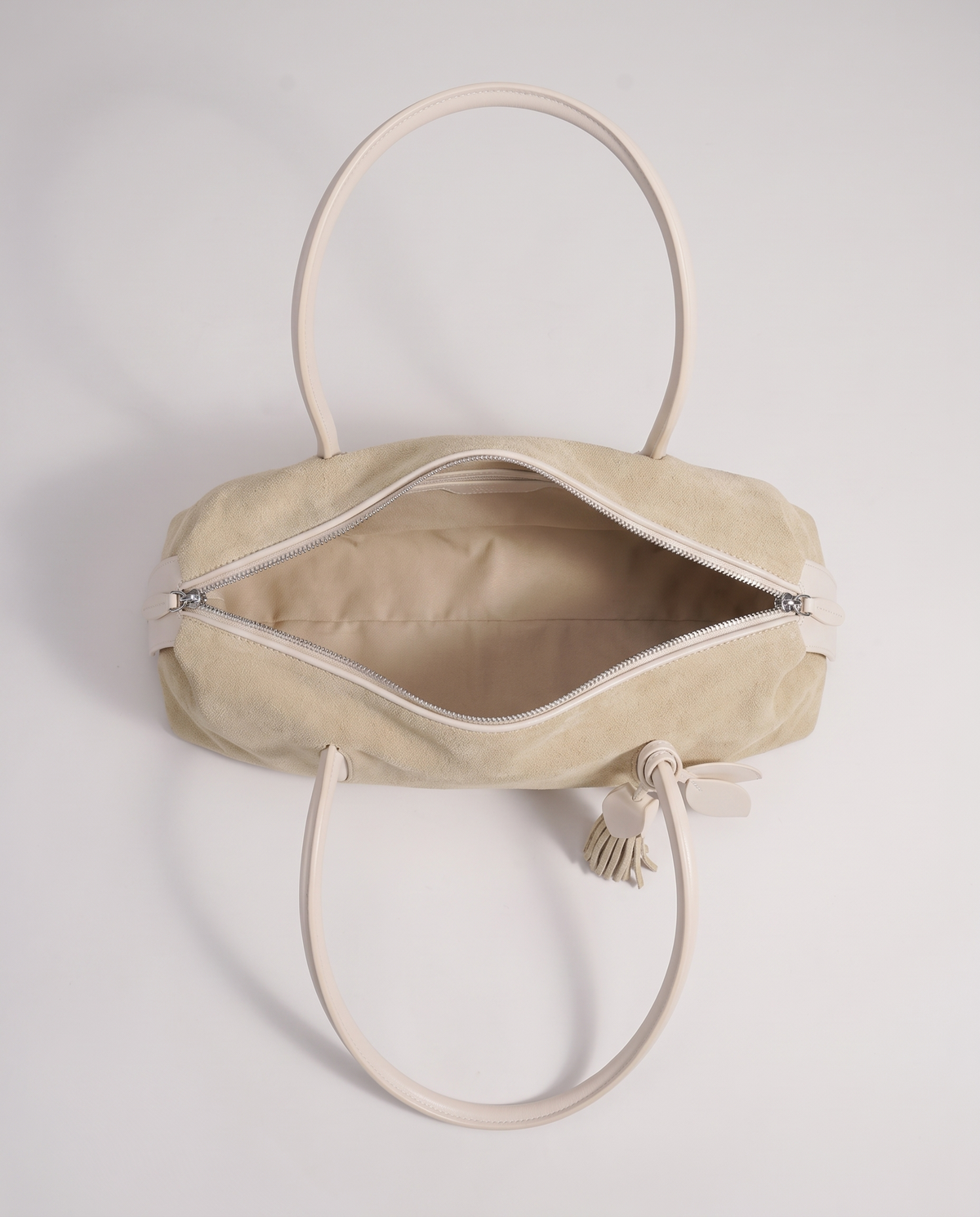 Isola suede shoulder bag in beige, open showing interior