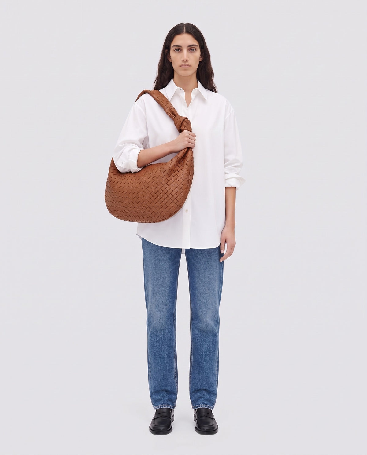Knot Maxi woven leather shoulder bag in Brown – model wearing it on the shoulder, full length