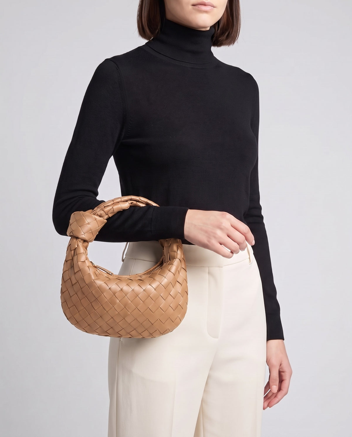 Knot Midi woven leather bag in Caramel – model carrying it