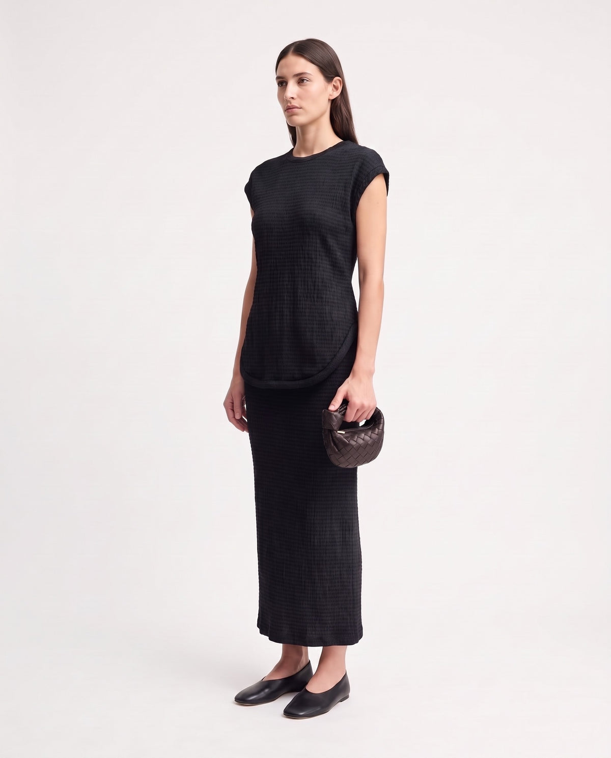 Knot Mini woven leather bag in Espresso – model holding it, full length