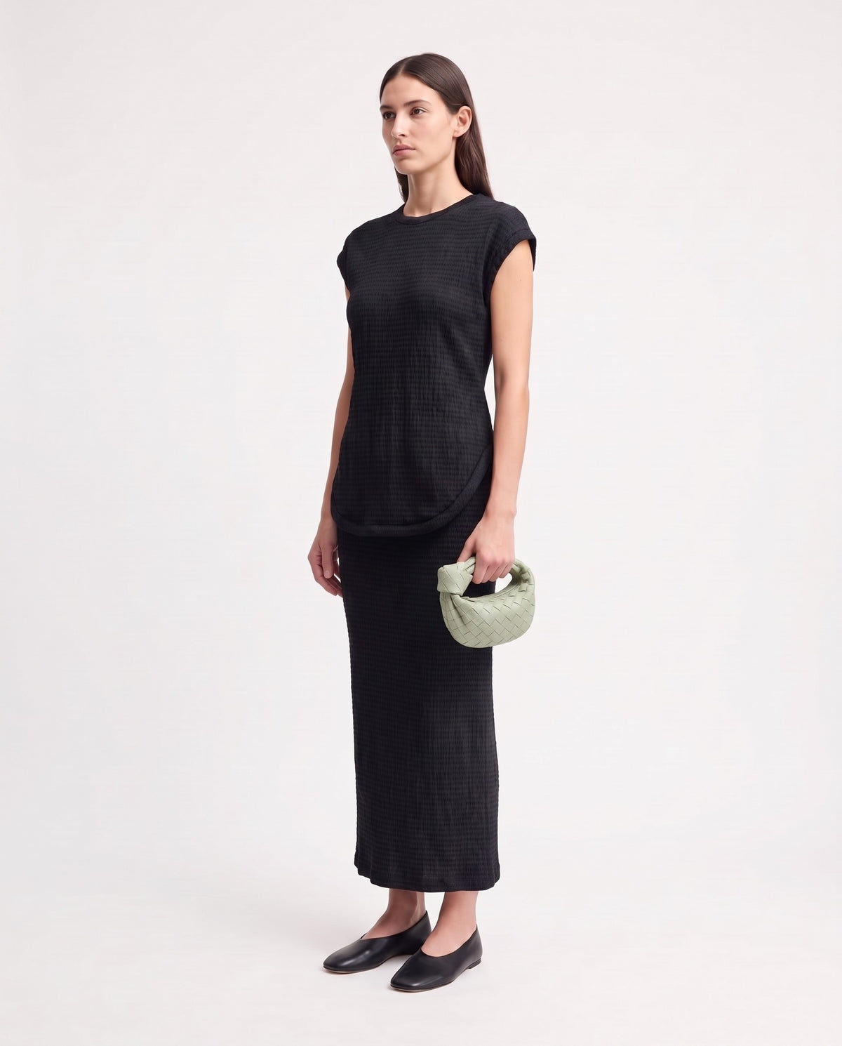 Knot Mini woven leather bag in Pistachio – model holding it, full length