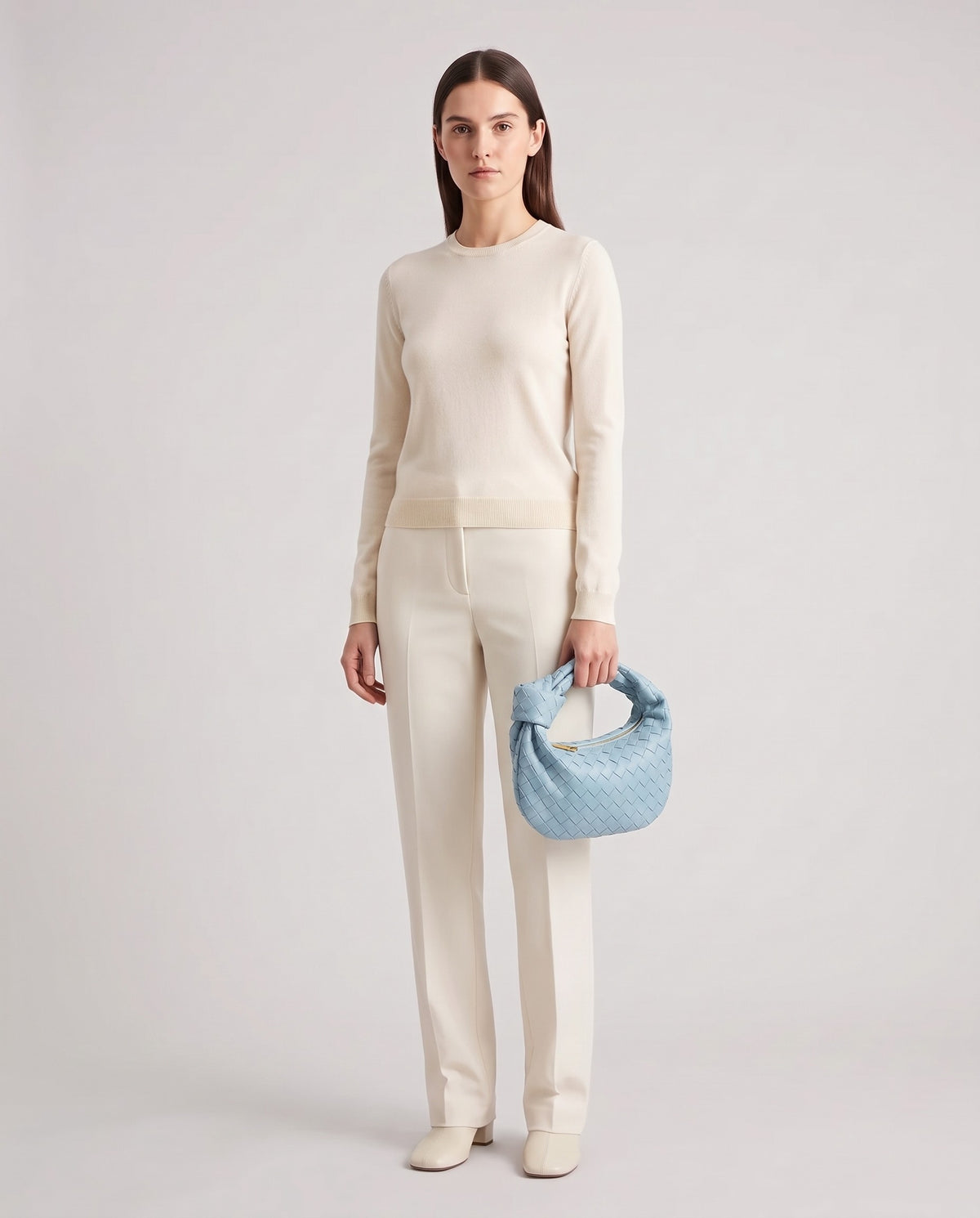 Knot Small woven leather bag in Sky Blue – model holding it, full length
