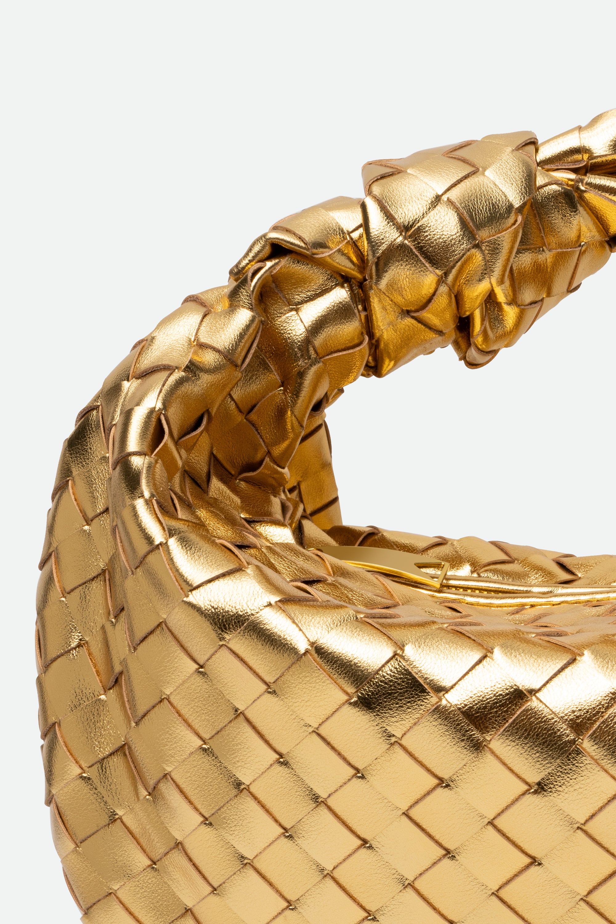 Close-up of Large Knot Bag (Jodie) gold woven handbag with a knotted handle.