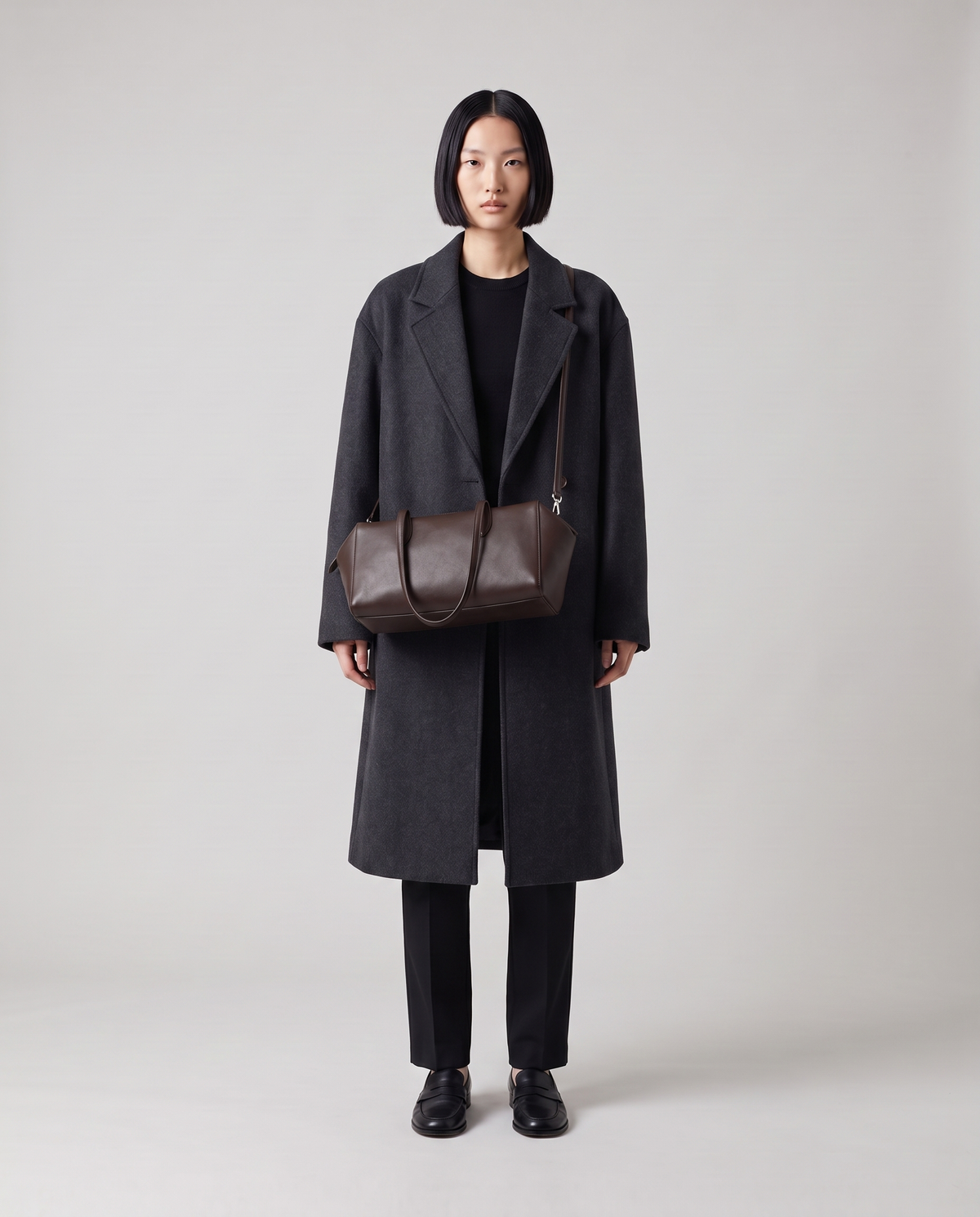 Lira leather shoulder bag in Espresso – model wearing it on her shoulder, full length