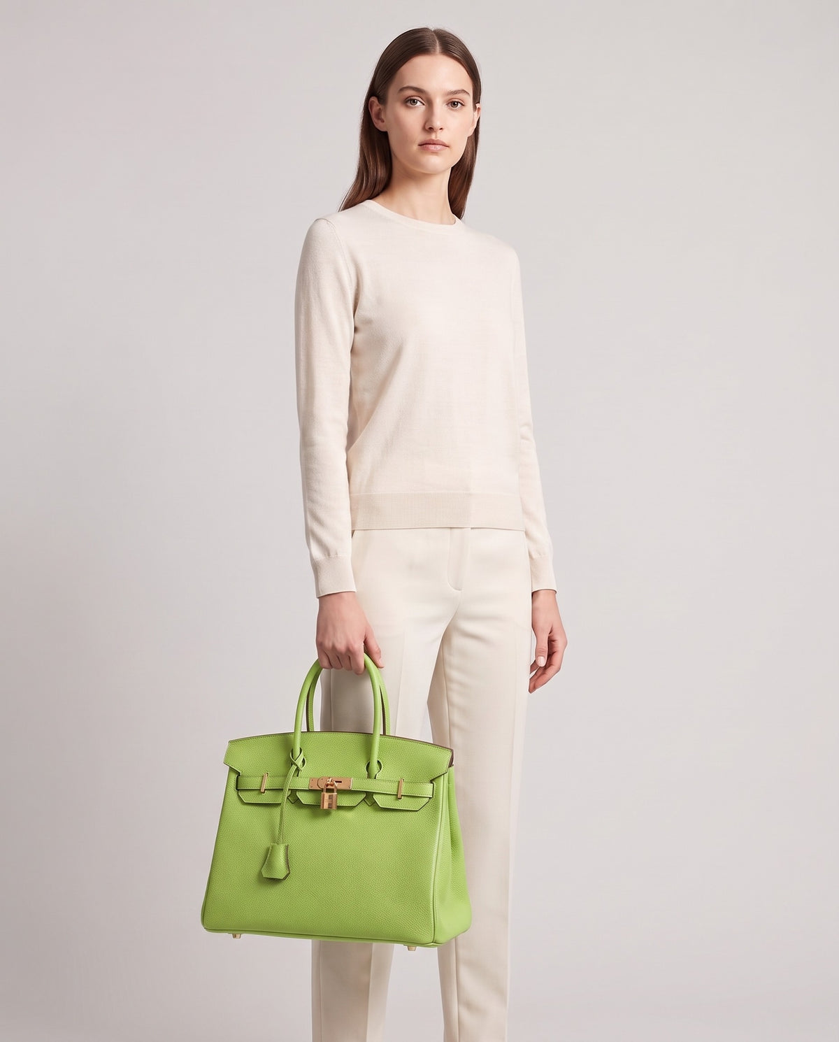 Lock Large leather top-handle bag in Avocado – model holding it, full length