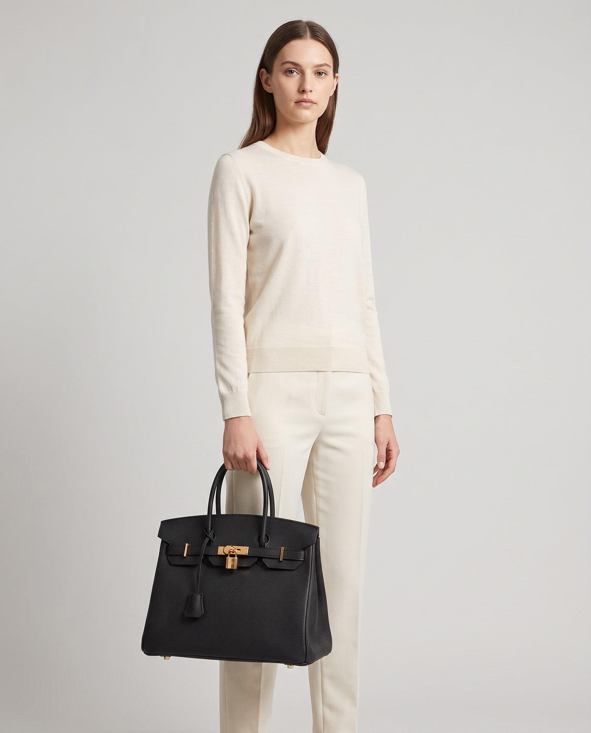 Lock Large leather top-handle bag in Black – model holding it, full length