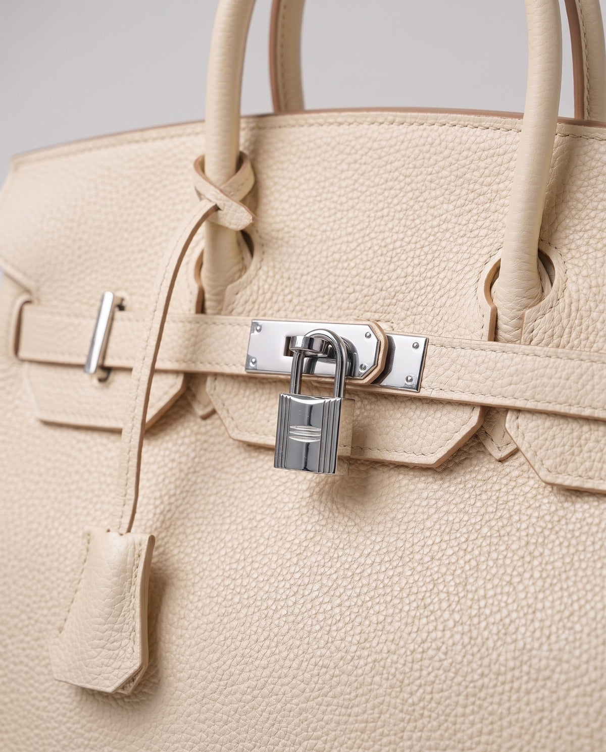 Lock Large leather top-handle bag in Cream – close-up of the silver turn-lock and padlock