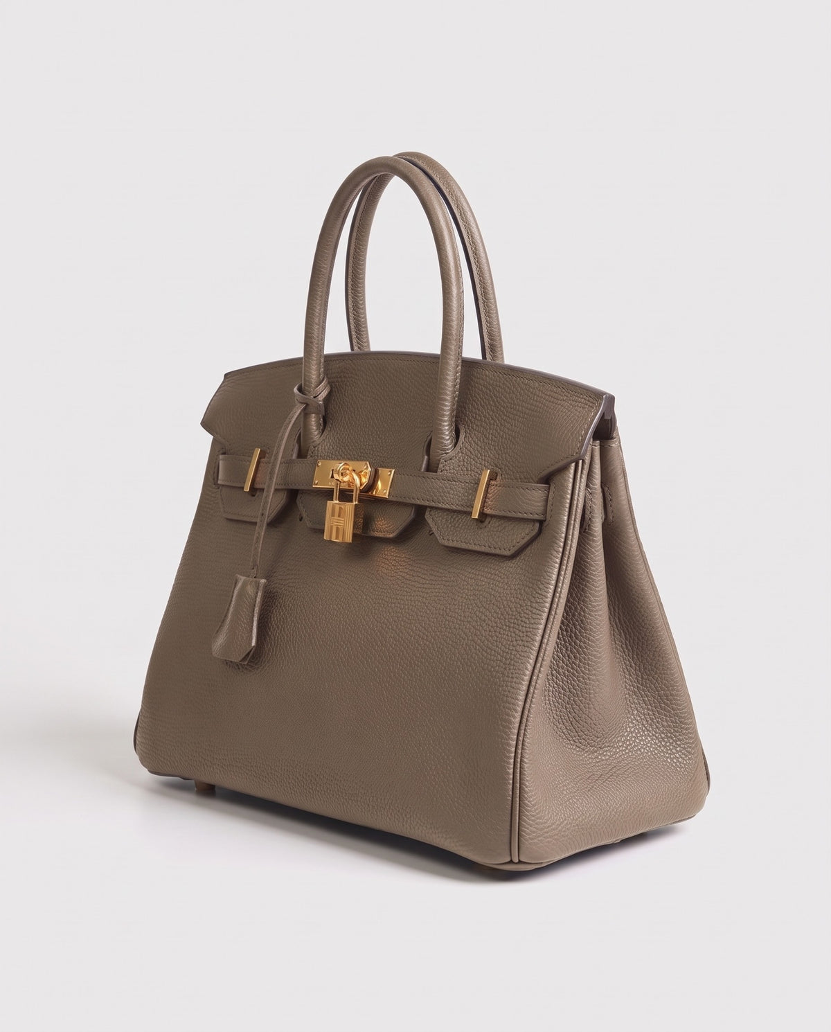 Lock Medium leather top-handle bag in Taupe – three-quarter view