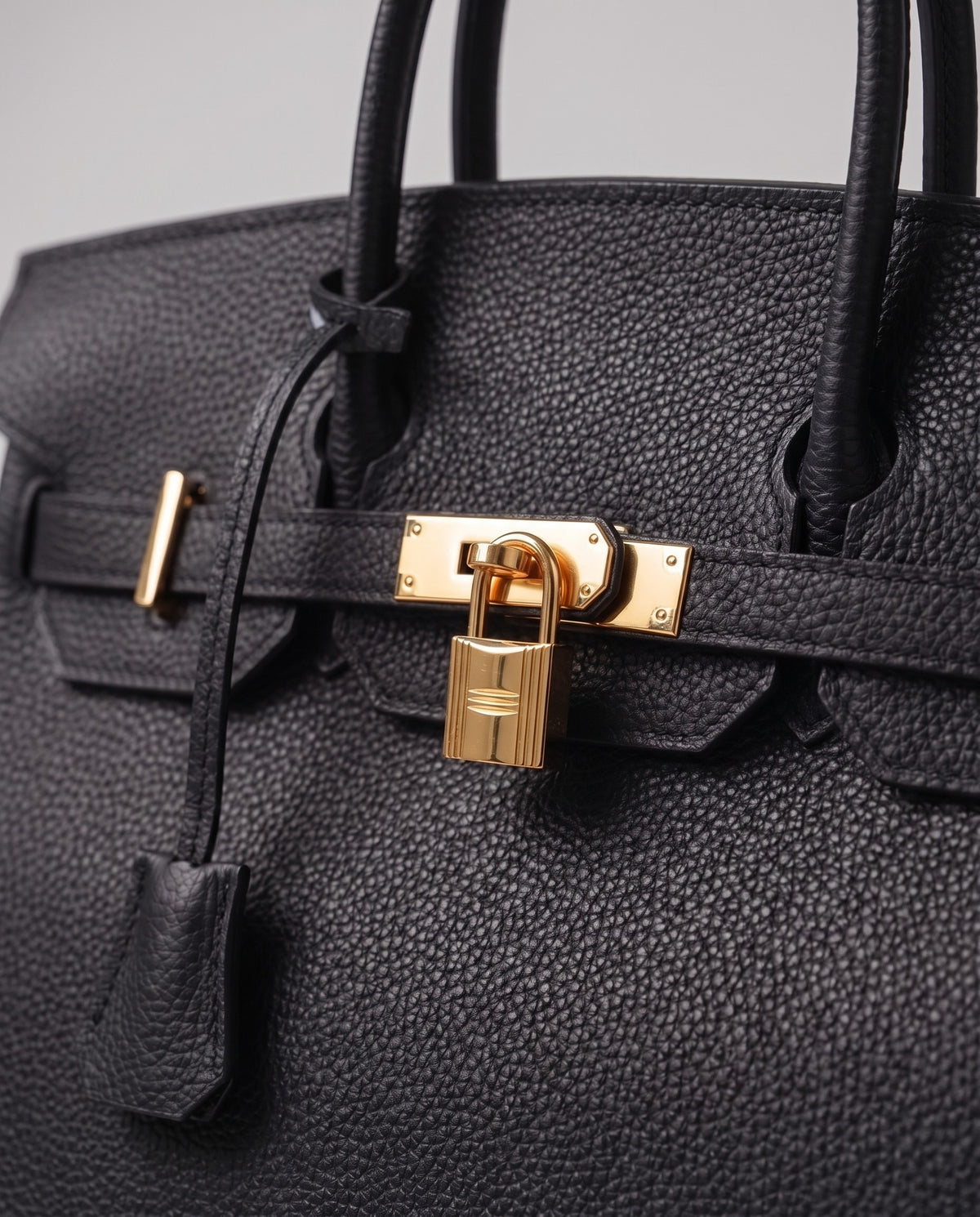 Lock Small leather top-handle bag in Black – close-up of the gold turn-lock and padlock