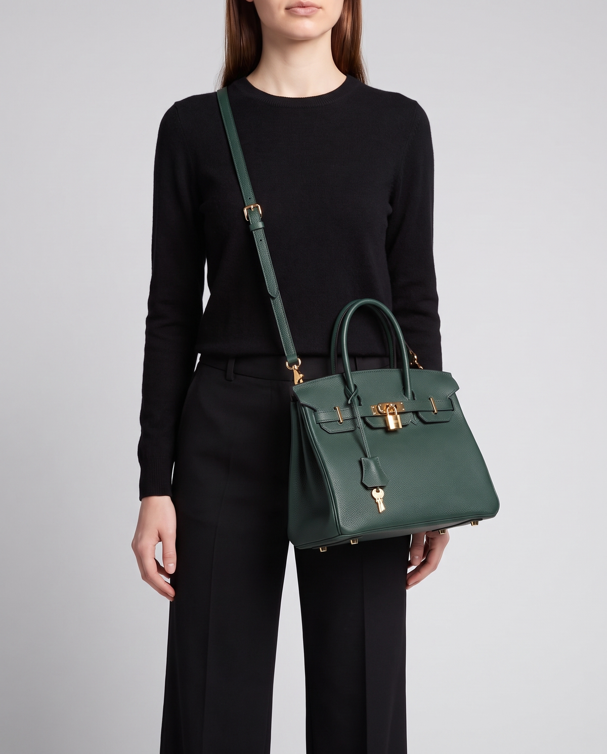 Lock Small leather top-handle bag in Emerald – model wearing it crossbody on the detachable shoulder strap