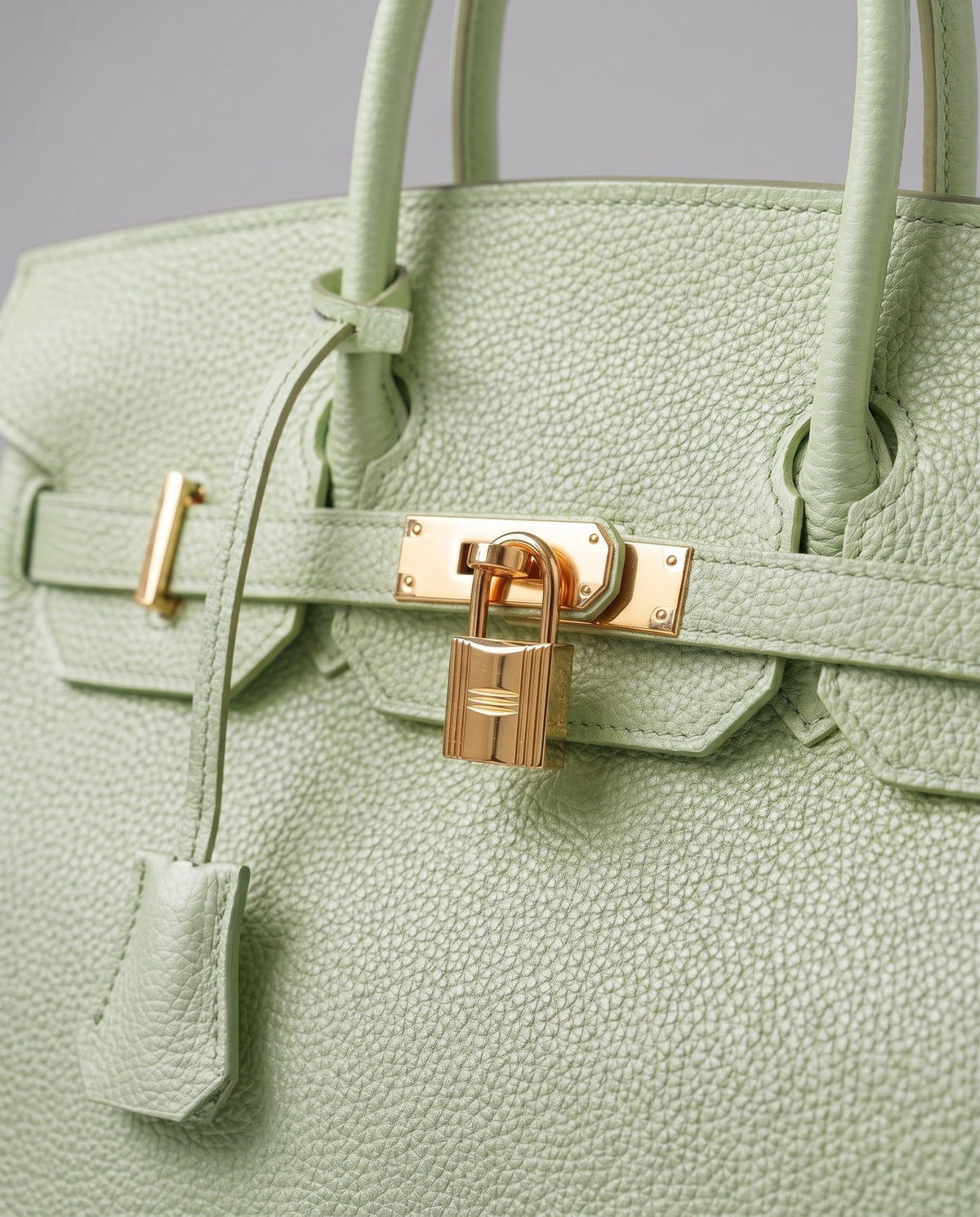 Lock Small leather top-handle bag in Mint – close-up of the gold turn-lock and padlock