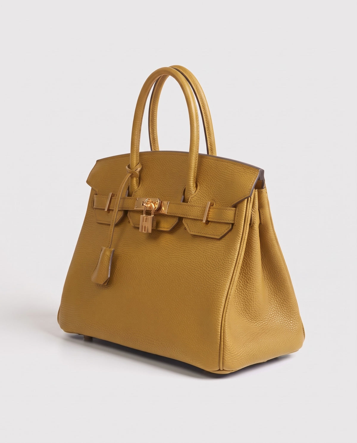 Lock Small leather top-handle bag in Mustard – three-quarter view